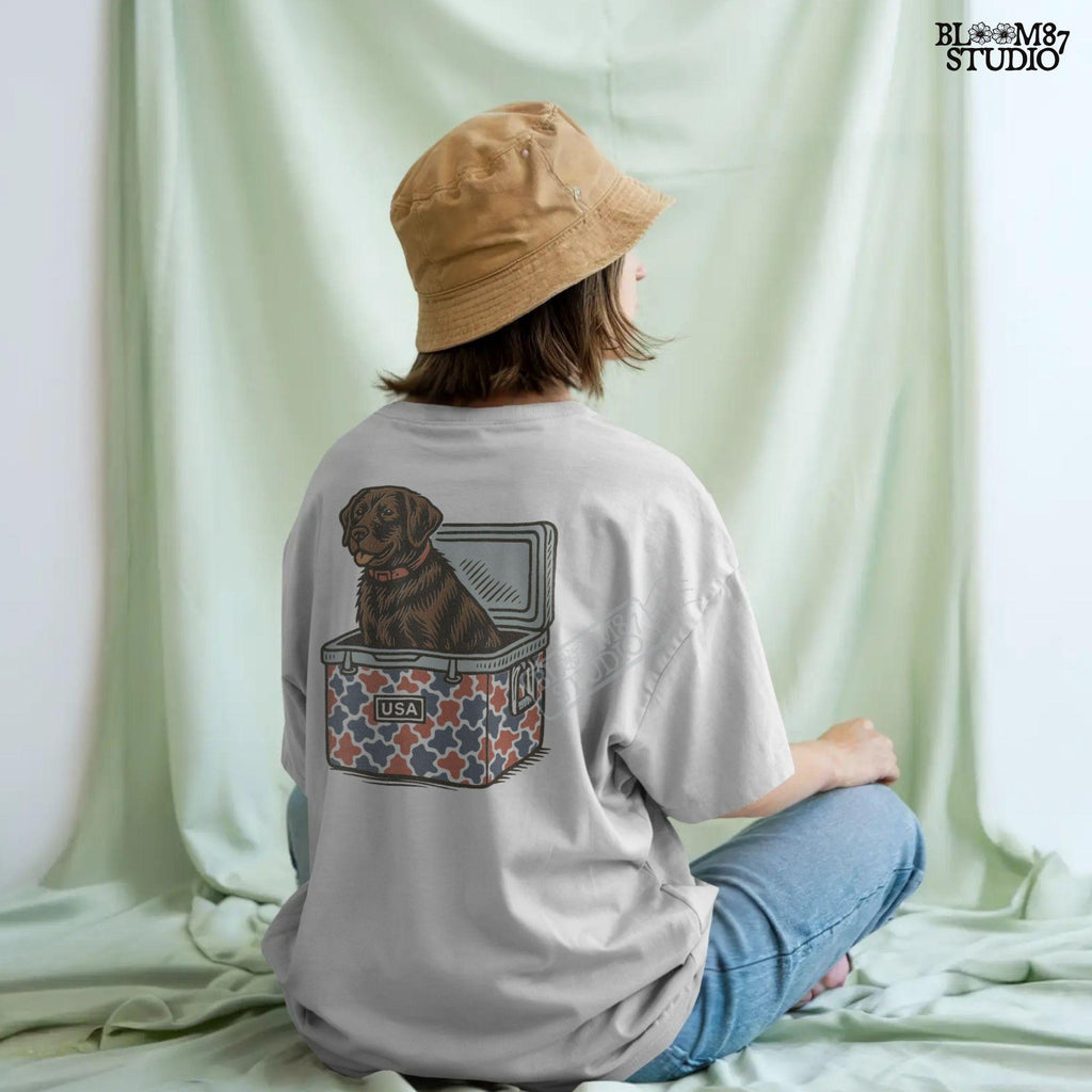 Patriotic sublimation PNG of a brown Labrador sitting inside a red, white, and blue USA-themed cooler, perfect for July 4th crafts and shirts