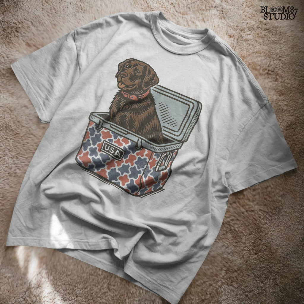 Patriotic sublimation PNG of a brown Labrador sitting inside a red, white, and blue USA-themed cooler, perfect for July 4th crafts and shirts