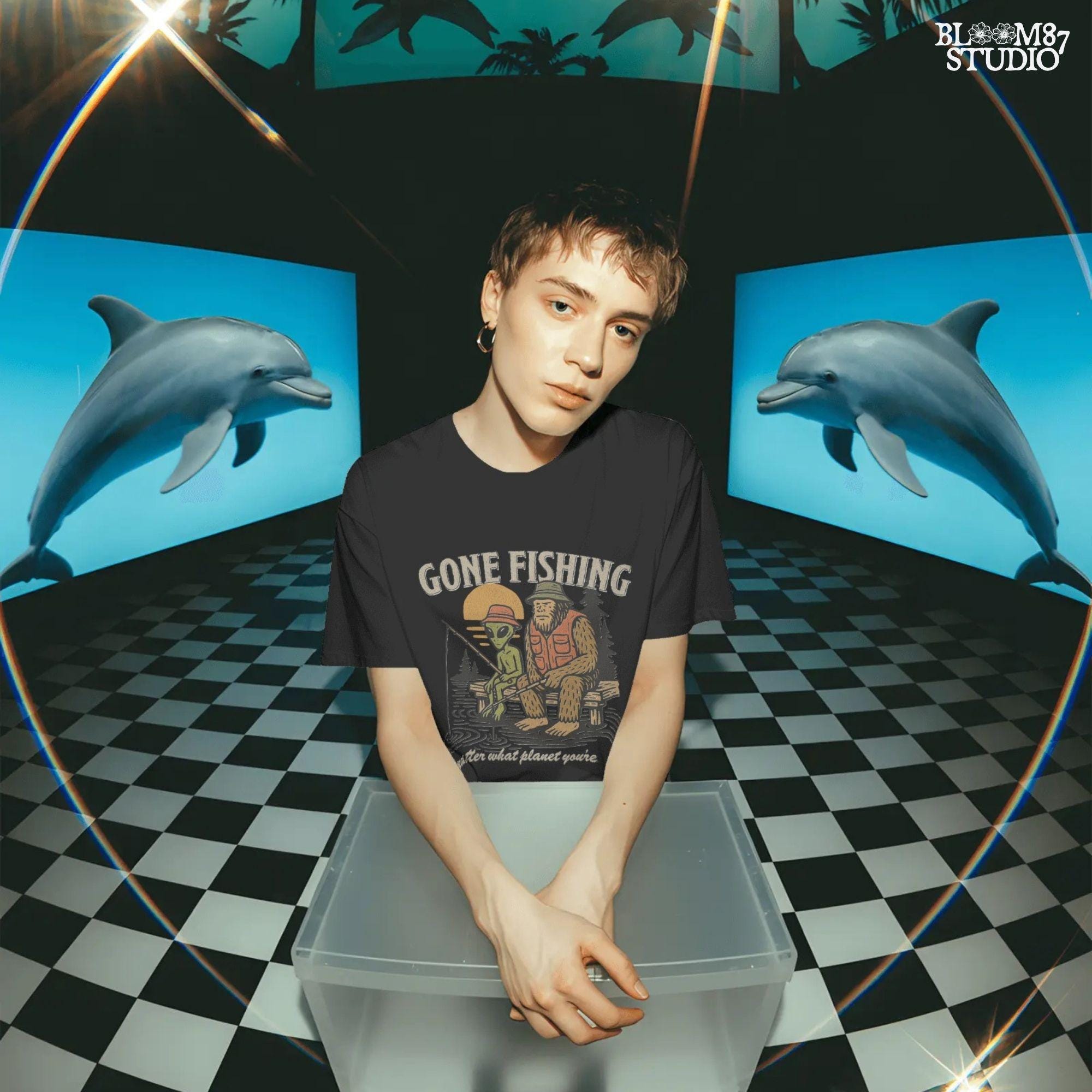 Funny illustration of Bigfoot and an alien fishing together on a lake dock at sunset, wearing fishing hats and vests—perfect for summer and Father’s Day sublimation.