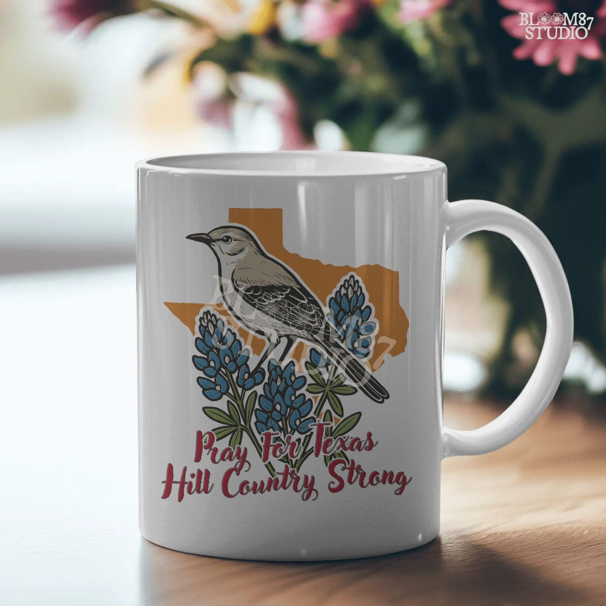 Illustration of a mockingbird on bluebonnets in front of Texas state outline with text “Pray for Texas Hill Country Strong,” designed for sublimation and awareness.