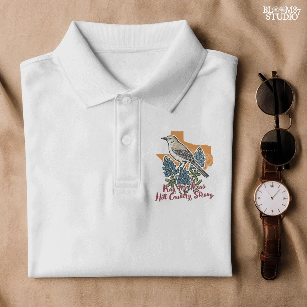 Illustration of a mockingbird on bluebonnets in front of Texas state outline with text “Pray for Texas Hill Country Strong,” designed for sublimation and awareness.