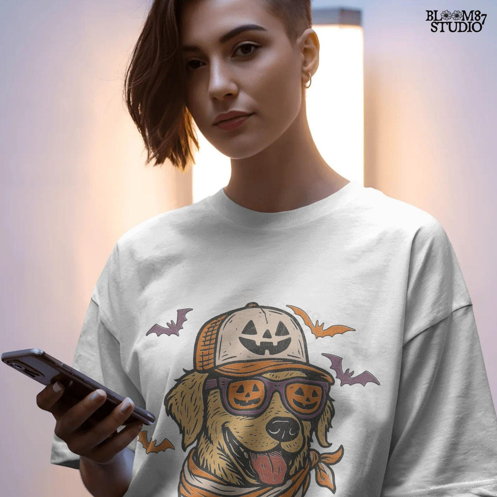 Golden retriever wearing jack-o’-lantern sunglasses, pumpkin hat, and orange bandana, surrounded by bats, Halloween-themed sublimation PNG