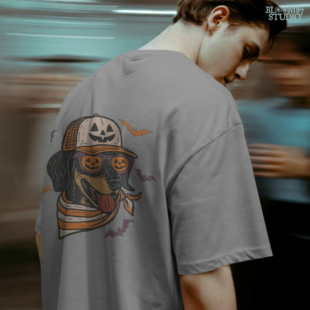 Halloween dachshund wearing pumpkin sunglasses, jack-o’-lantern hat, and orange bandana with flying bats, sublimation PNG design