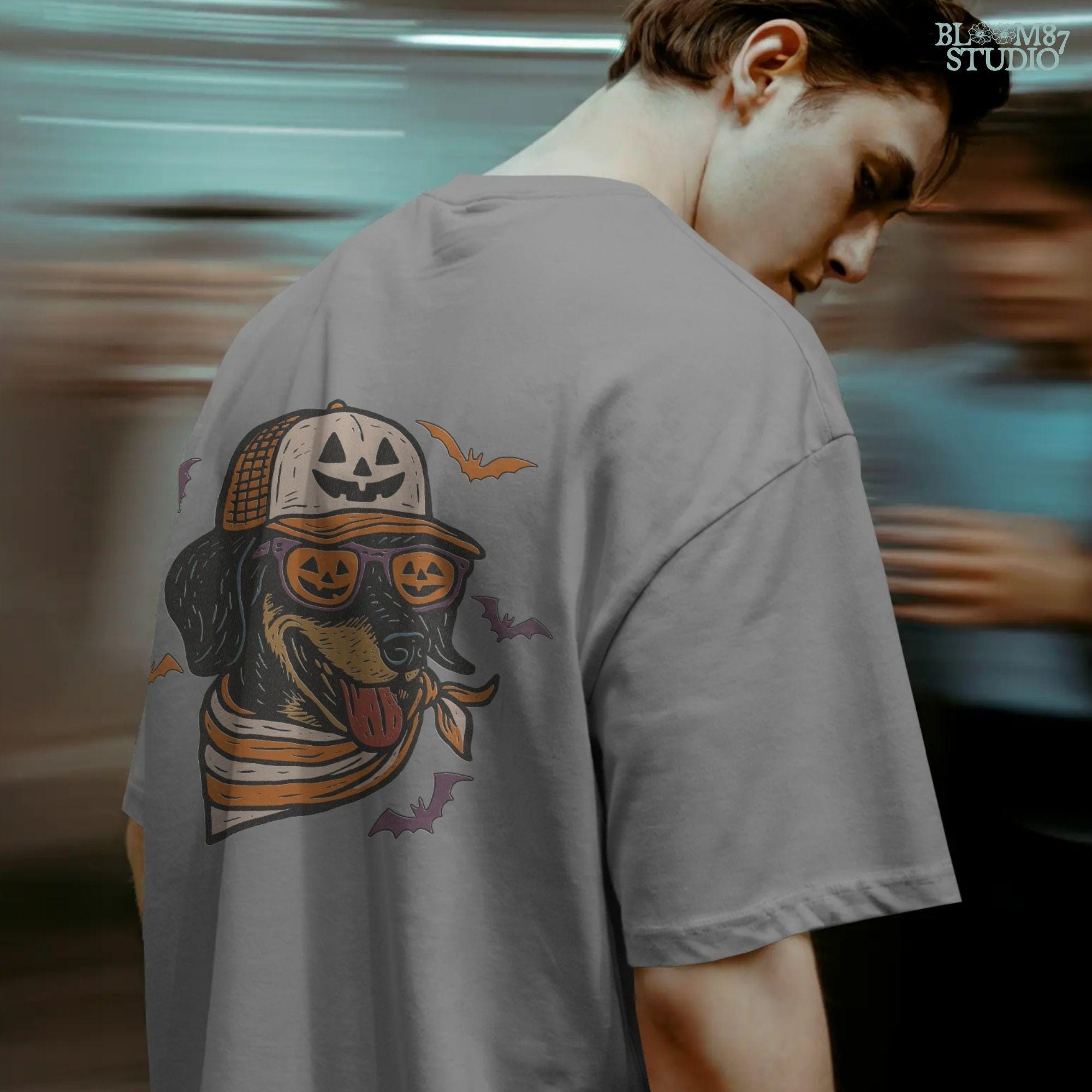 Halloween dachshund wearing pumpkin sunglasses, jack-o’-lantern hat, and orange bandana with flying bats, sublimation PNG design