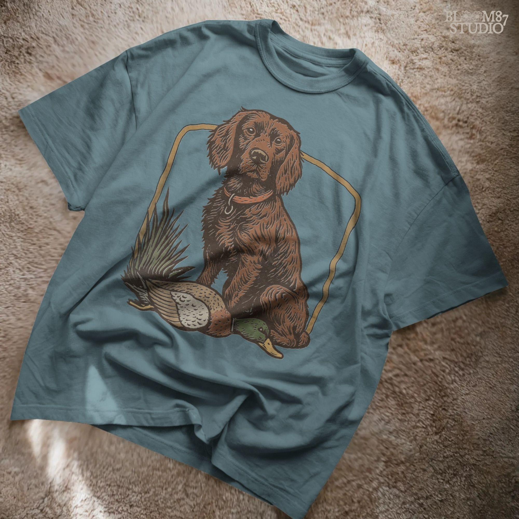 Vintage-style PNG of a Boykin Spaniel dog sitting with a harvested mallard duck, perfect for fall hunting sublimation and Southern dog lovers