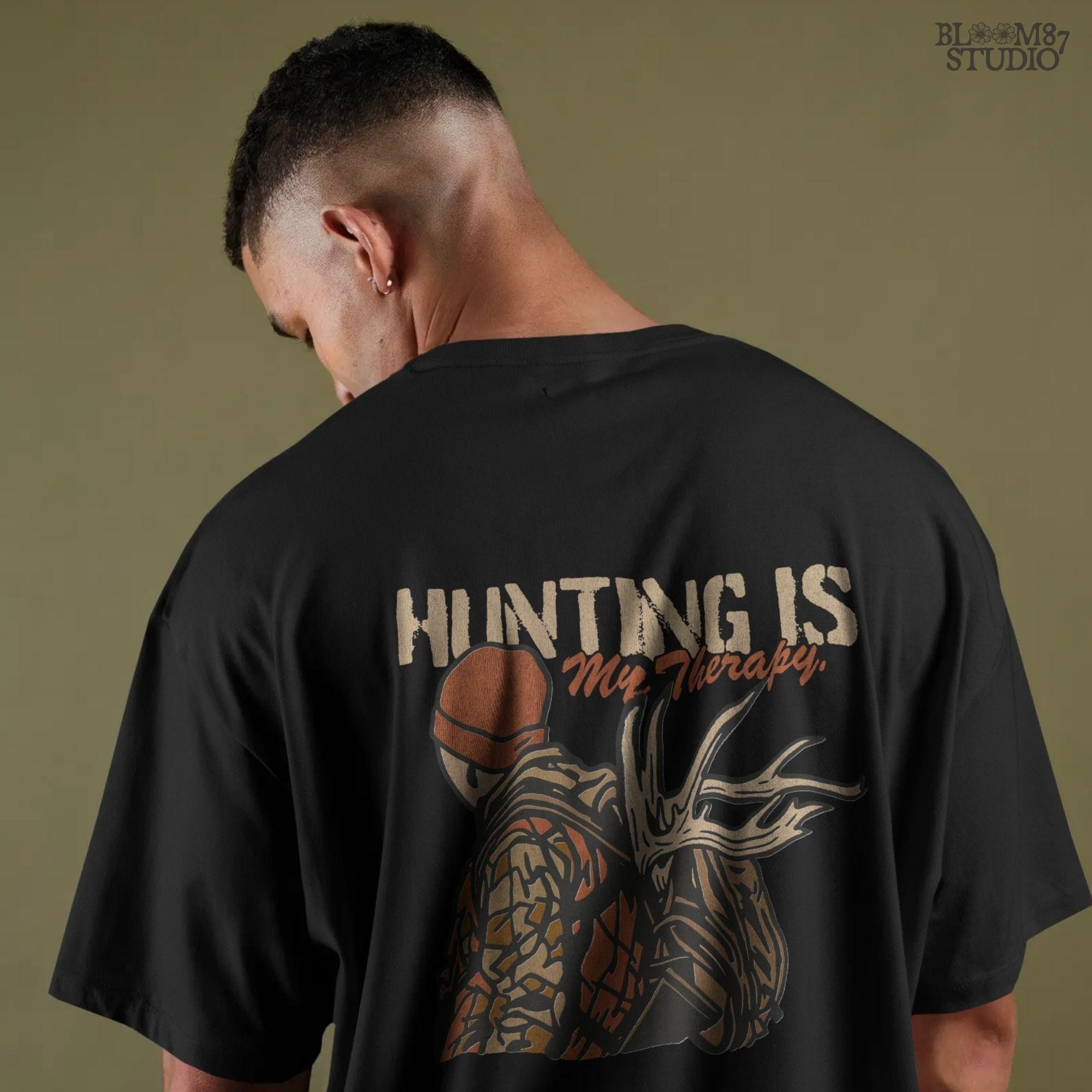 A camouflage hunter with antlers on backpack and text “Hunting Is My Therapy,” designed for fall hunting season sublimation and outdoor-themed apparel.