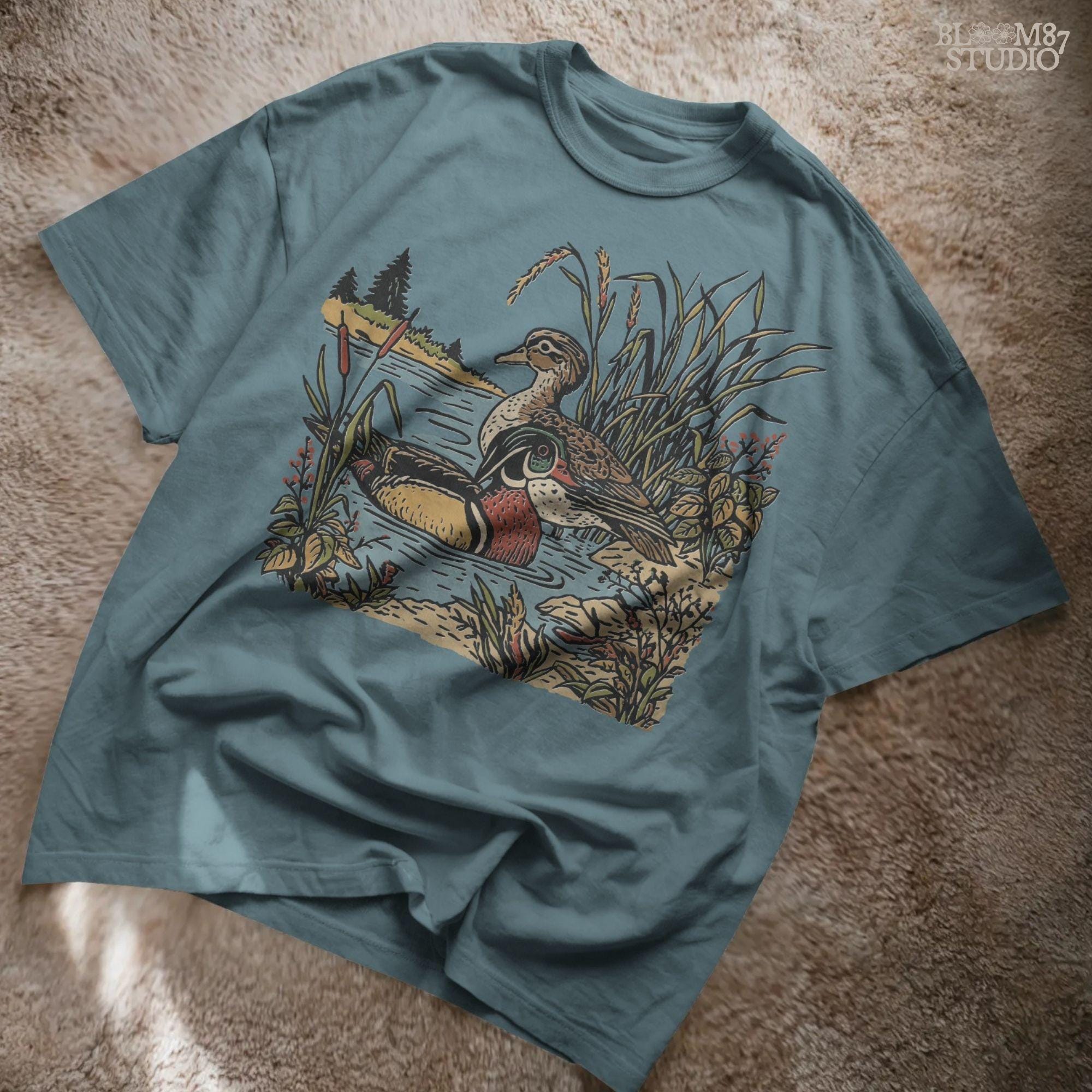 Vintage-style sublimation PNG of two wood ducks in a fall marsh surrounded by cattails and foliage, designed for duck hunting shirts and gifts