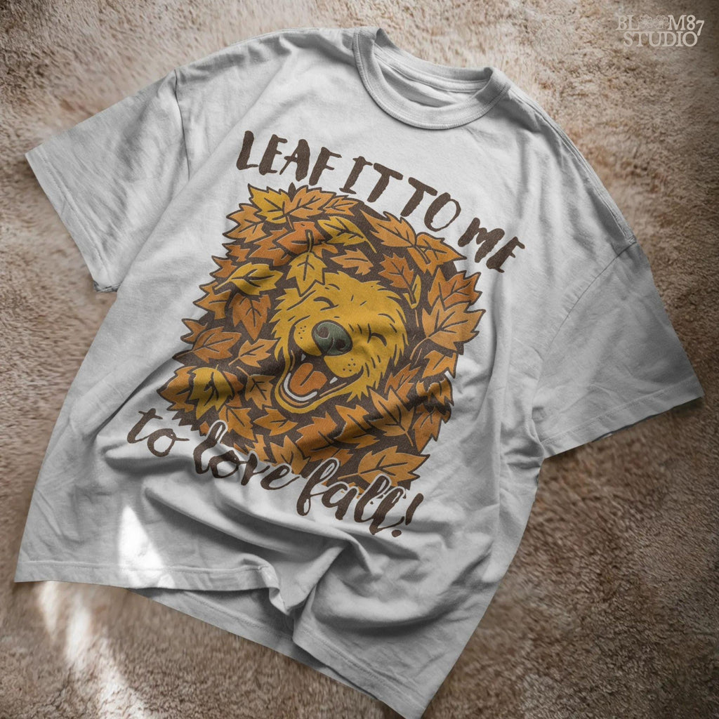 Cute golden retriever surrounded by fall leaves with the phrase “Leaf it to me to love fall”, for autumn dog-themed sublimation projects