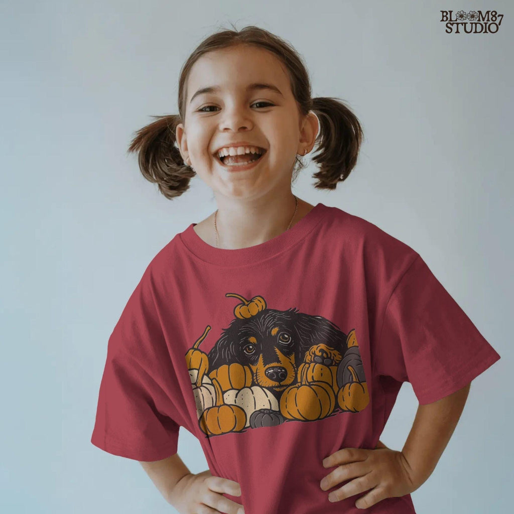 Long-haired dachshund surrounded by fall pumpkins in orange, cream, and gray tones, perfect for autumn sublimation designs and shirts