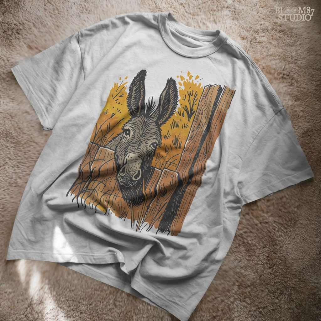 Vintage-style donkey looking through a rustic wooden fence with golden fall foliage in the background, perfect for sublimation crafts