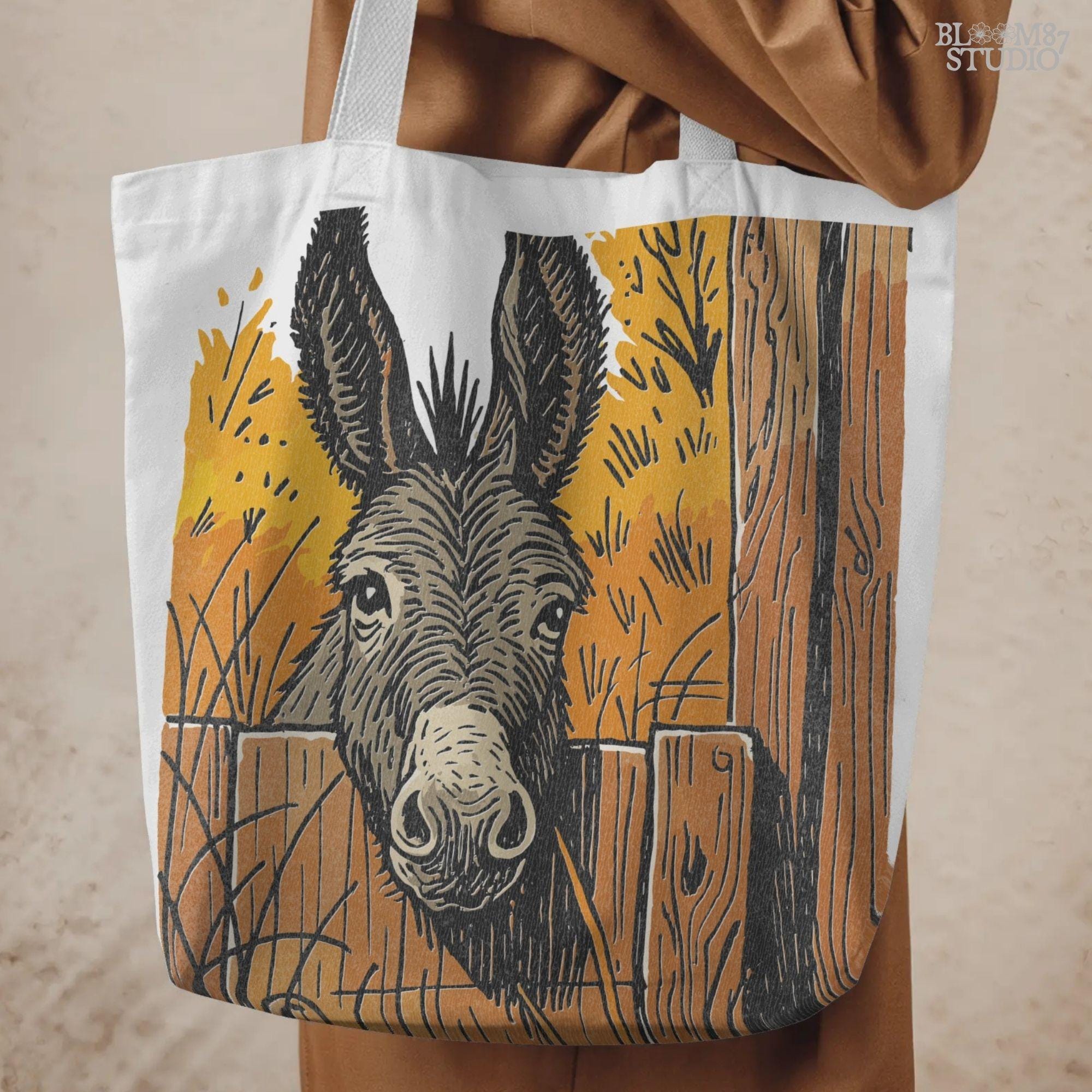 Vintage-style donkey looking through a rustic wooden fence with golden fall foliage in the background, perfect for sublimation crafts