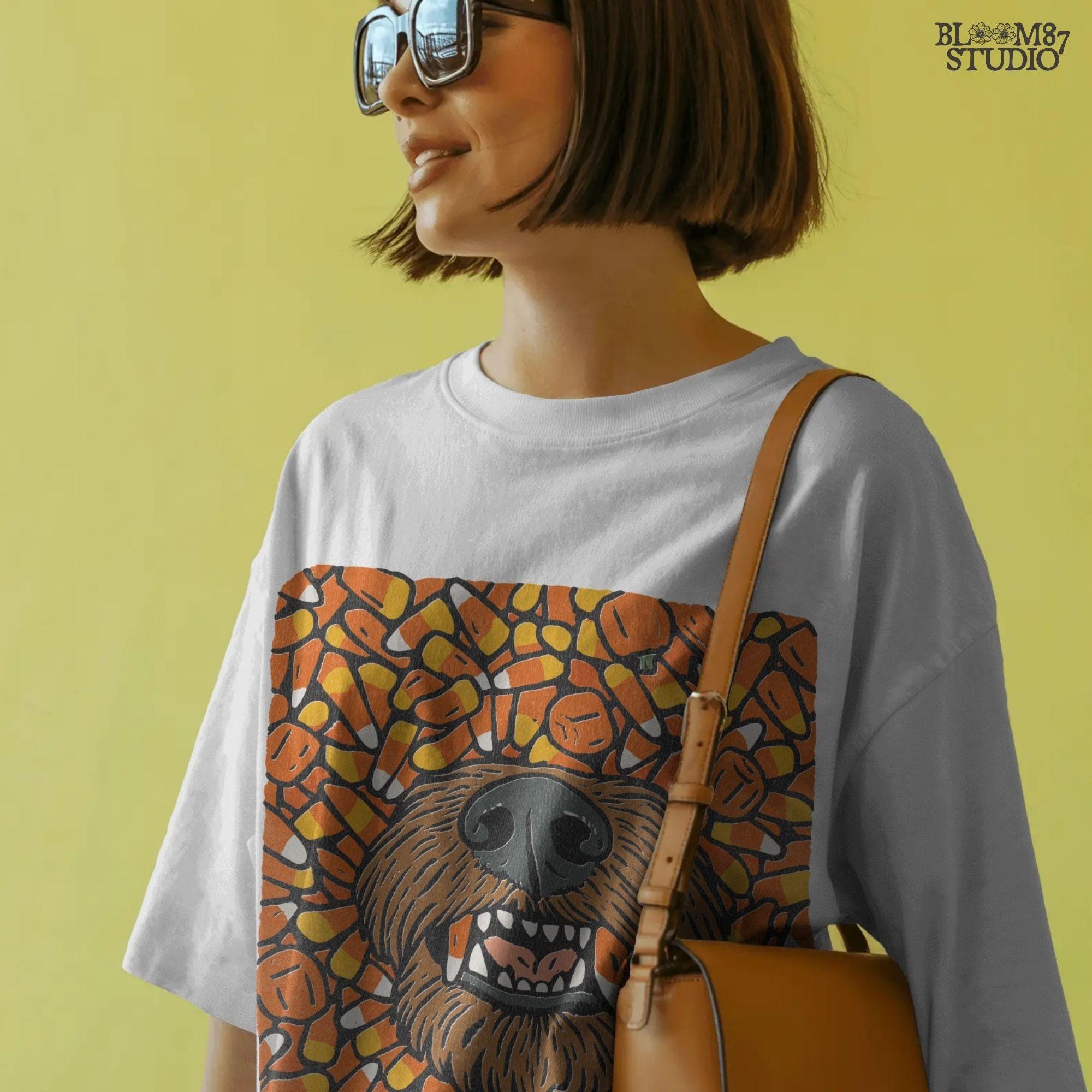 Funny werewolf-style dog face surrounded by candy corn and pumpkins in a Halloween-themed sublimation design