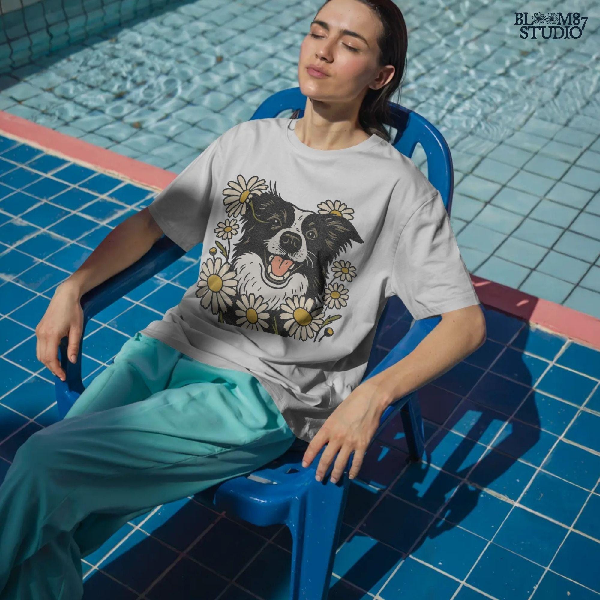 Happy Border Collie dog surrounded by white and yellow daisy flowers in a spring floral sublimation PNG design