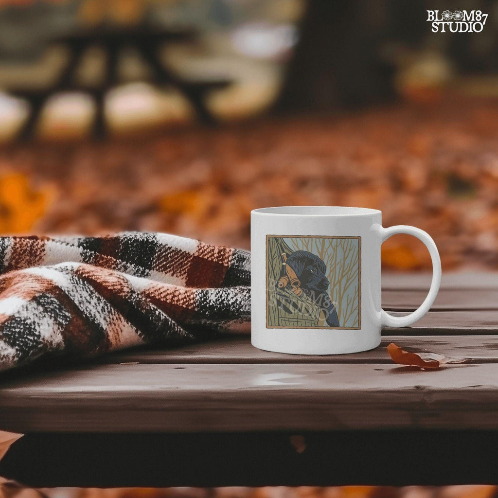 Black Labrador puppy sitting in a camo hunting vest with duck calls, perfect for fall hunting season sublimation designs.