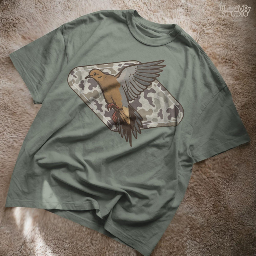 Illustration of a flying mourning dove over a tan and brown camo-patterned background, designed for hunting-themed sublimation prints.