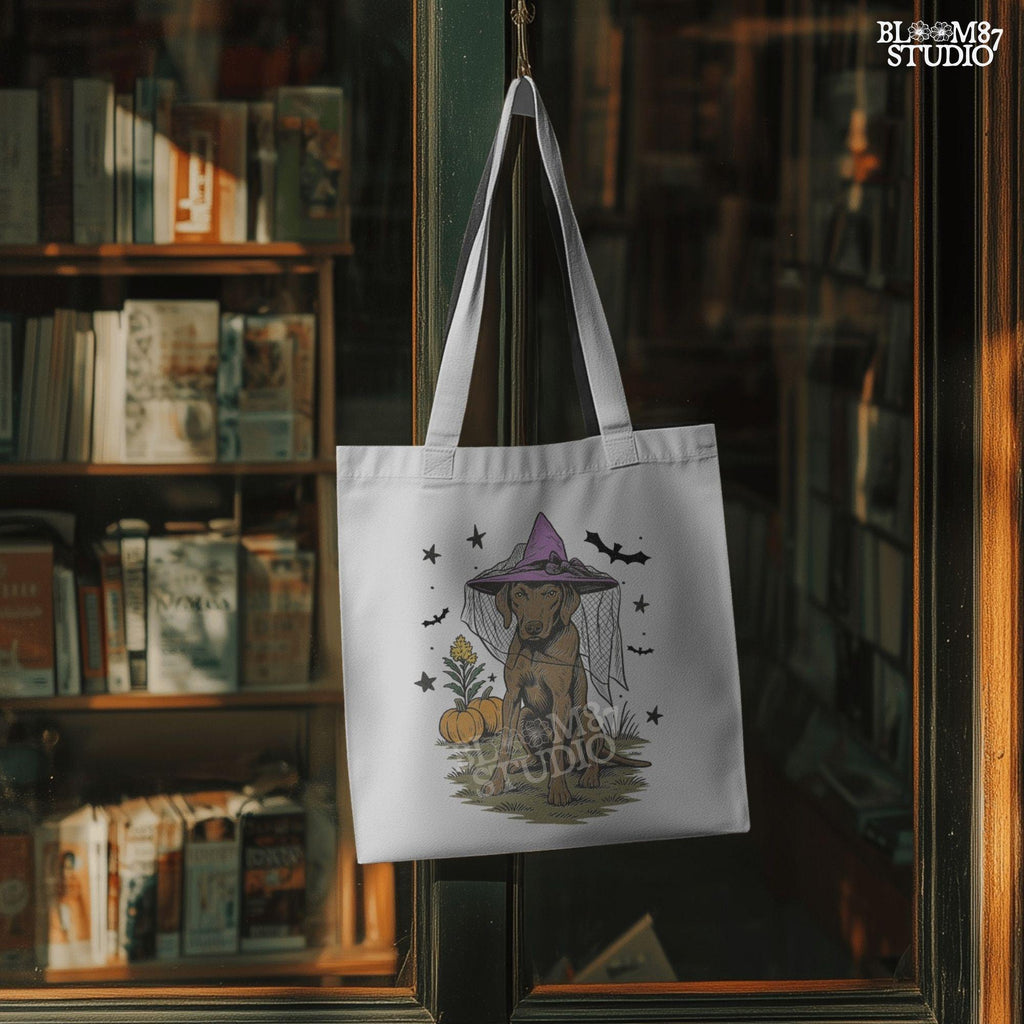 Illustration of a brown labrador wearing a witch hat, sitting in grass with pumpkins and stars in the background, in Halloween spooky style.