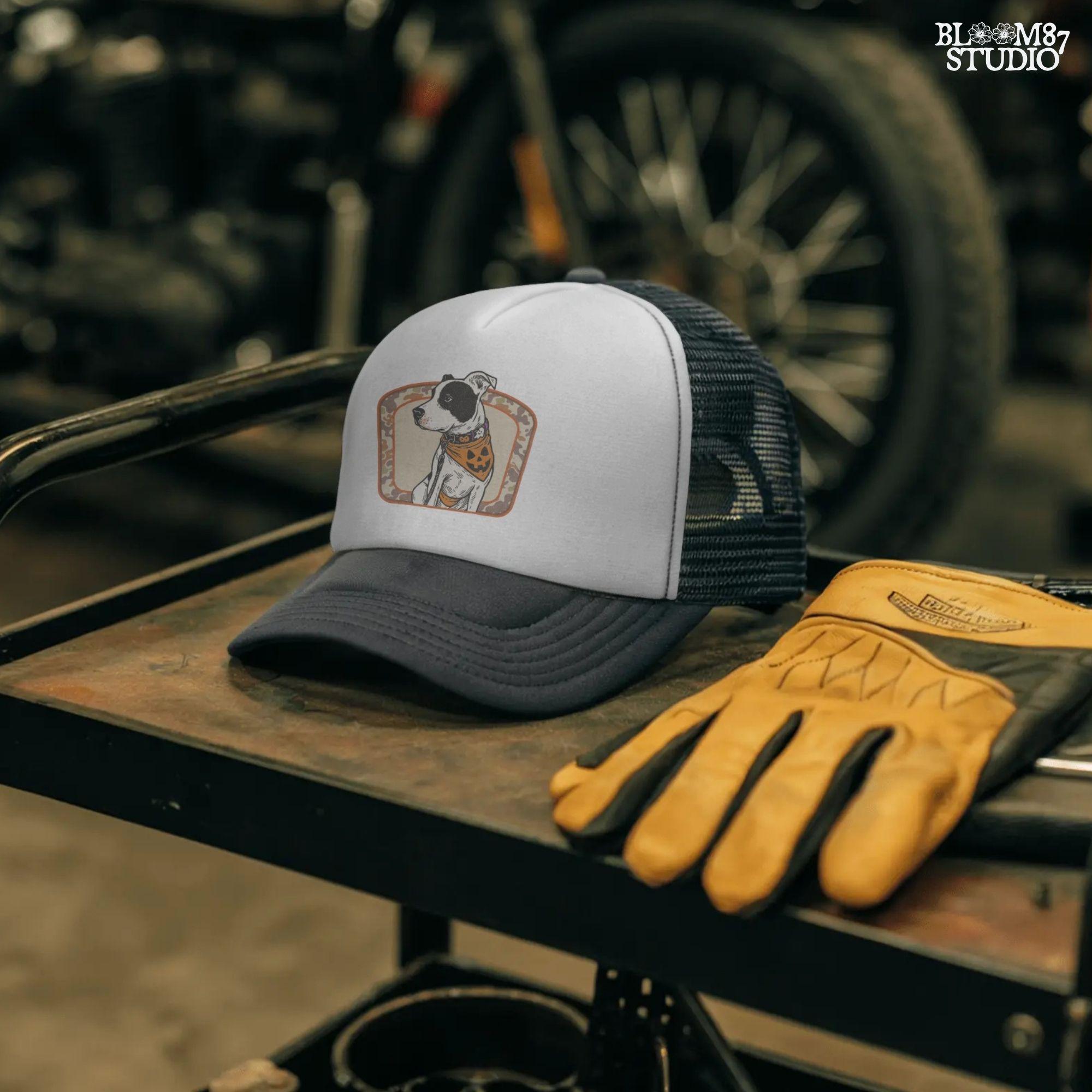 Illustration of a black and white pitbull wearing a jack-o’-lantern bandana and Halloween collar, framed by a camo background.