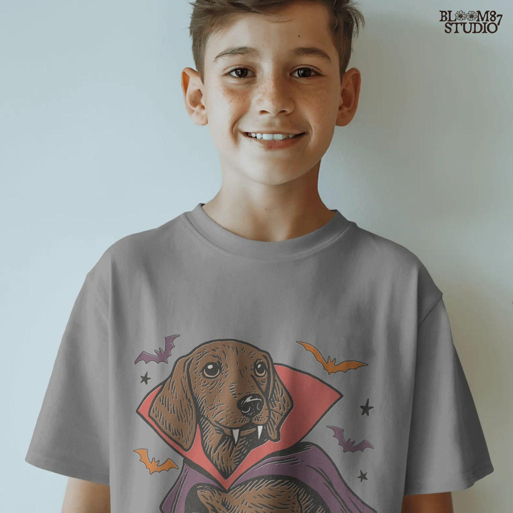 Cute dachshund dressed as a Halloween vampire with red and purple cape, fangs, and surrounded by bats on transparent background.