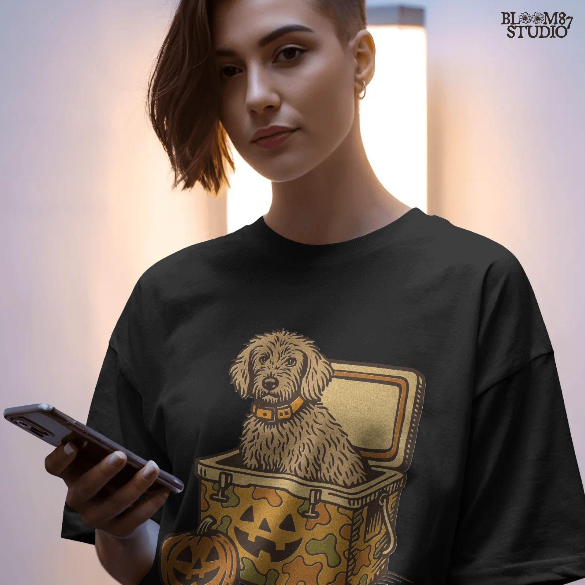 Cute golden doodle dog sitting in a Halloween camo cooler with jack-o’-lantern face, fall-themed sublimation graphic on transparent background.