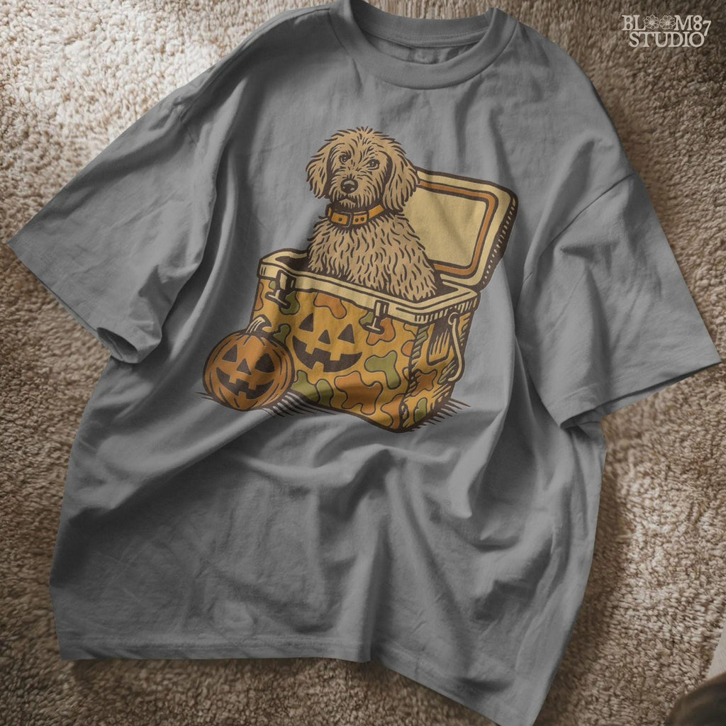 Cute golden doodle dog sitting in a Halloween camo cooler with jack-o’-lantern face, fall-themed sublimation graphic on transparent background.