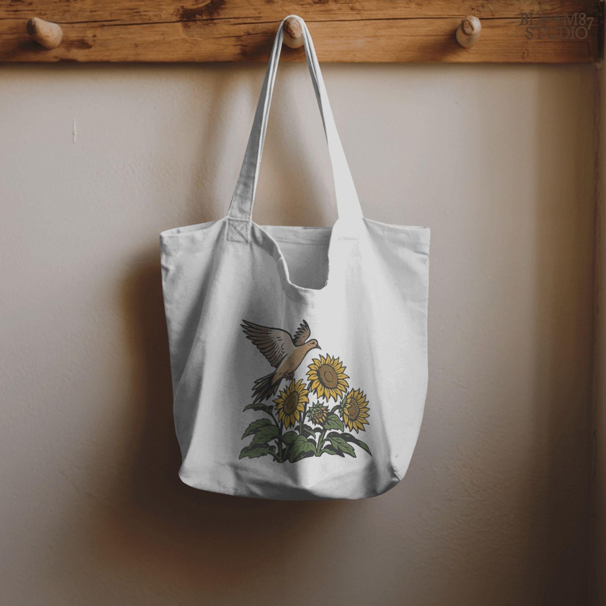 Mourning dove flying above blooming sunflowers with green leaves. Rustic sublimation PNG design for fall and country-themed crafts.