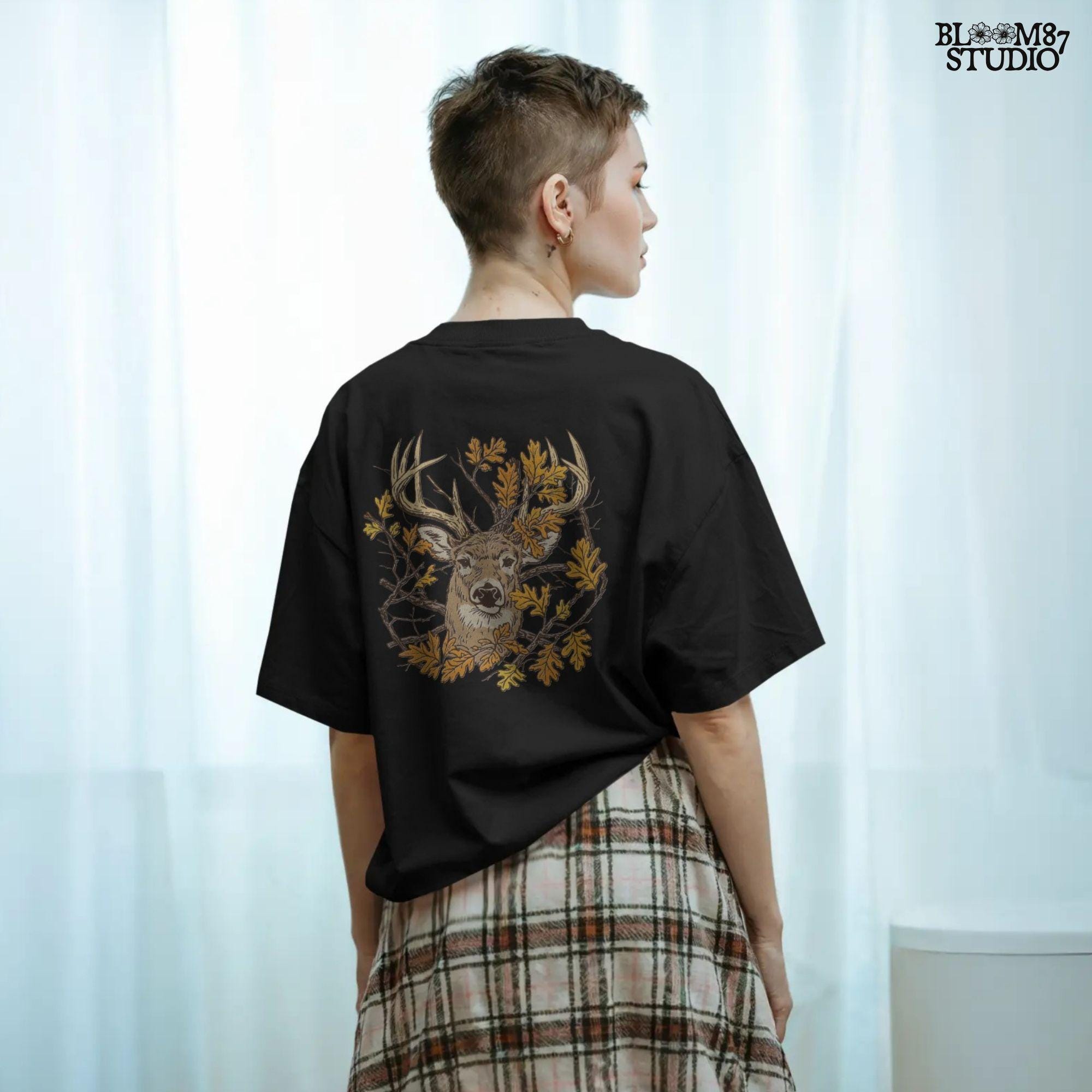 Illustration of a whitetail deer head with large antlers surrounded by golden autumn oak leaves and forest branches, rustic fall theme.