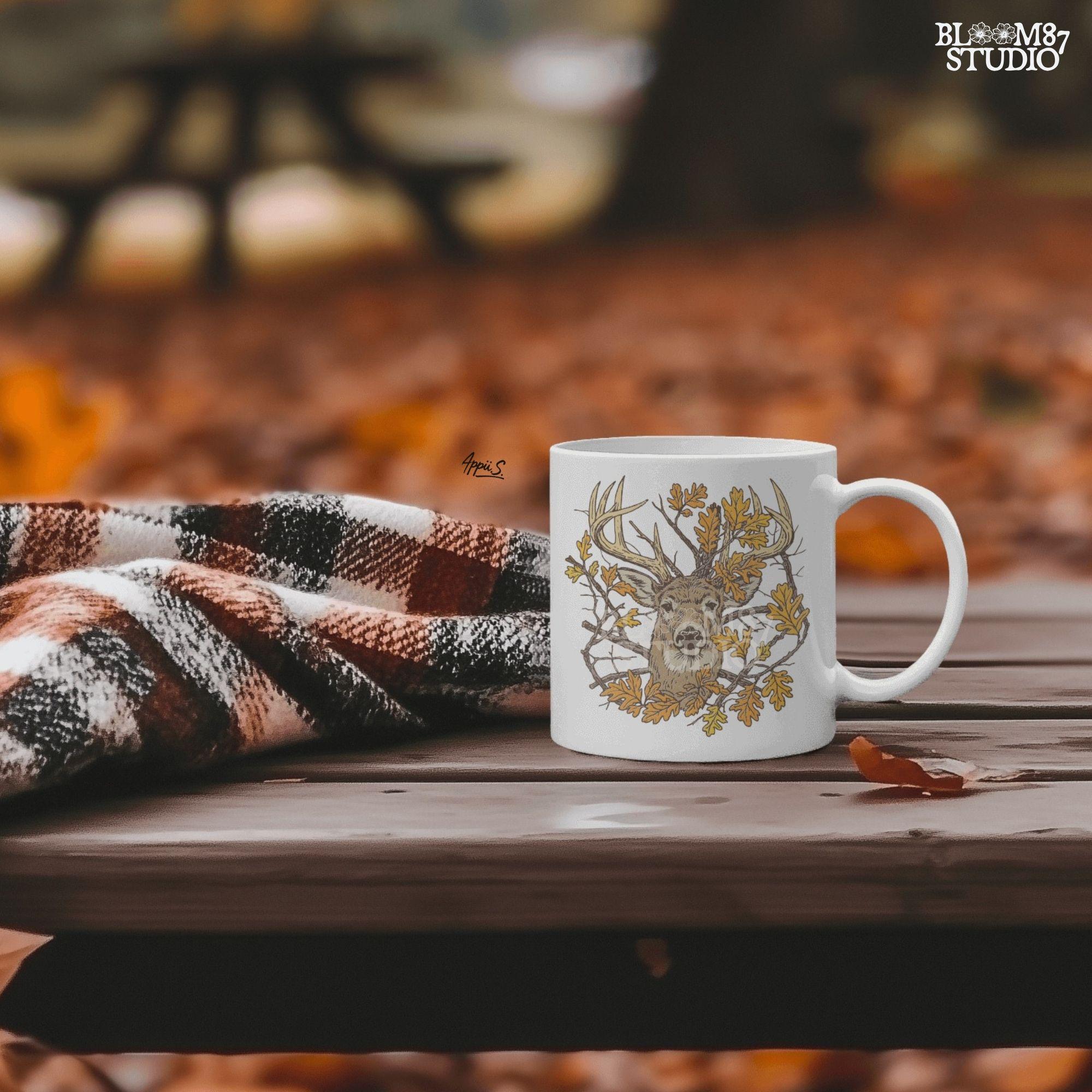 Illustration of a whitetail deer head with large antlers surrounded by golden autumn oak leaves and forest branches, rustic fall theme.