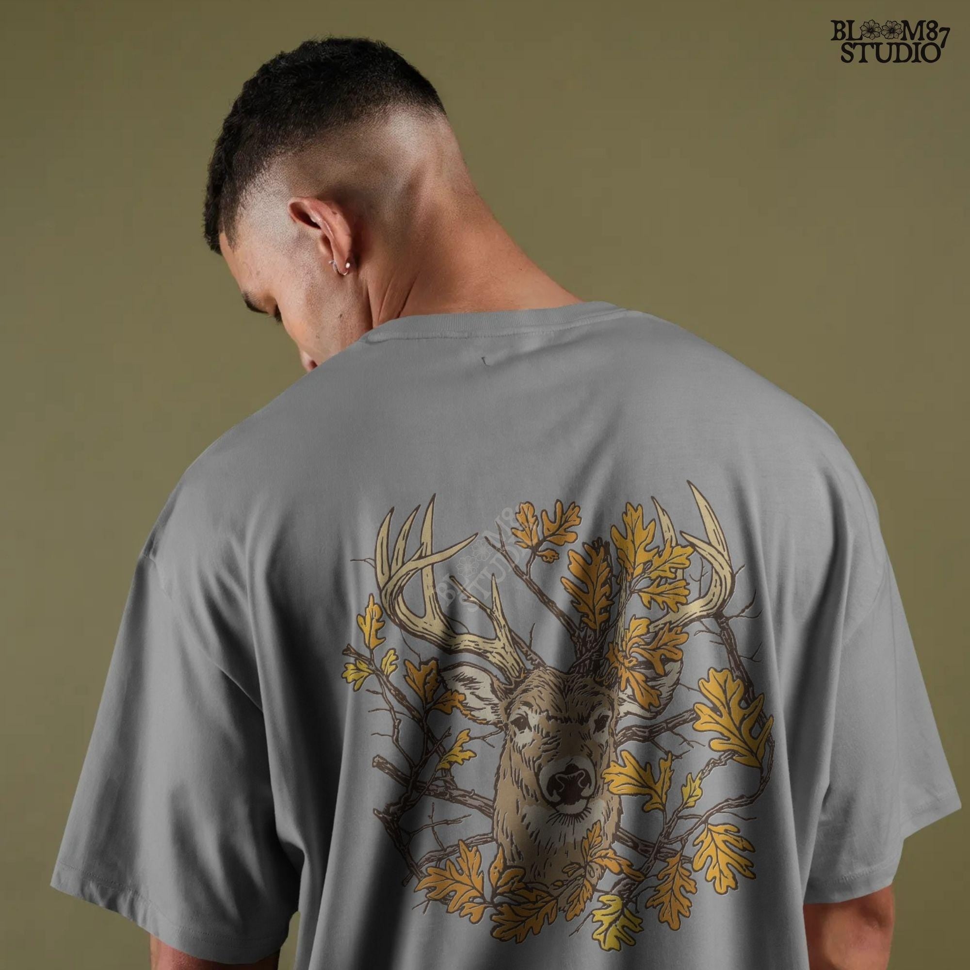 Illustration of a whitetail deer head with large antlers surrounded by golden autumn oak leaves and forest branches, rustic fall theme.