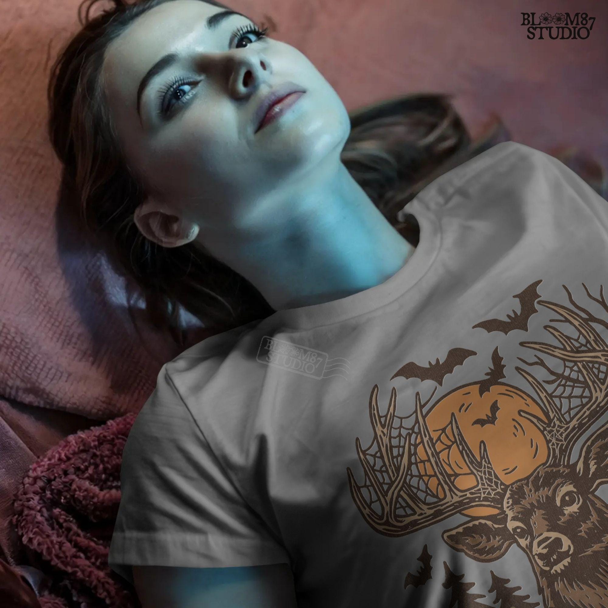 Halloween-themed sublimation PNG of a deer with spiderweb antlers, jack-o’-lantern pumpkins, bats, and a spooky forest background.