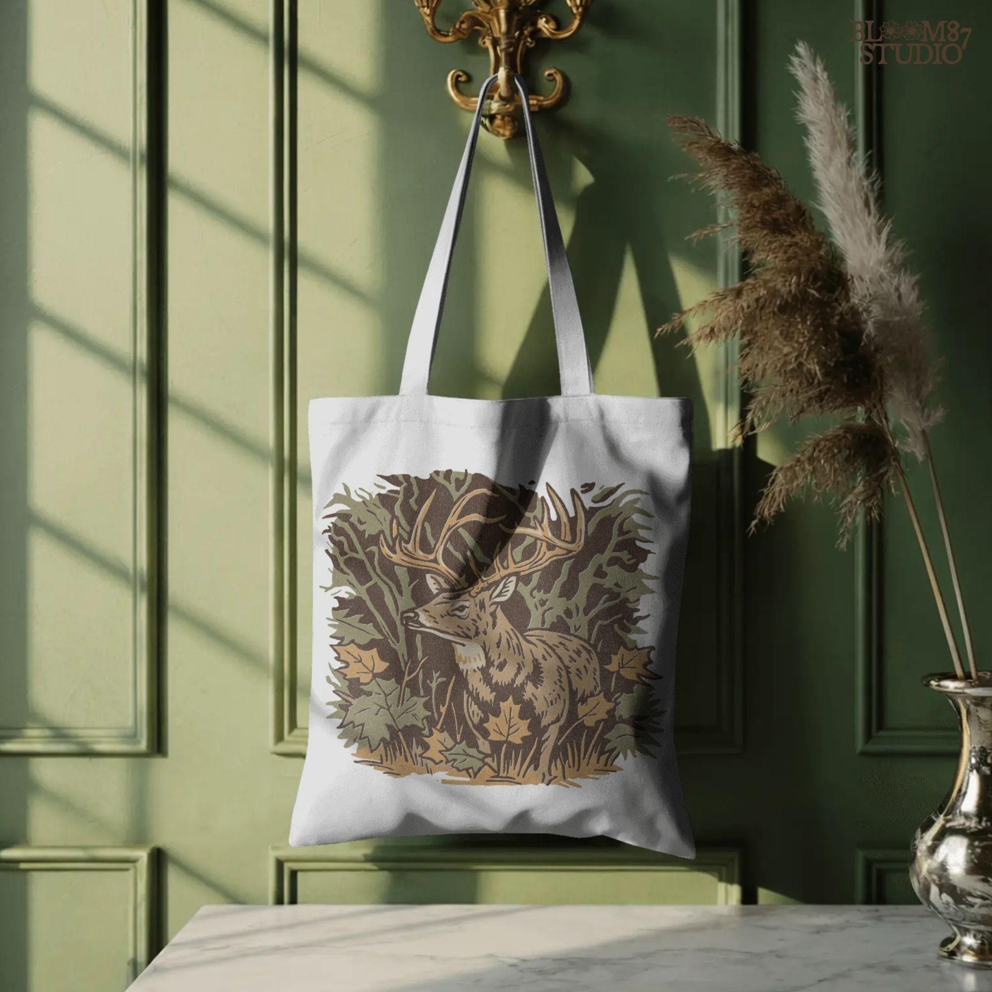Illustration of a whitetail buck in a fall forest surrounded by autumn leaves, ideal for rustic sublimation or hunting-themed shirt design.