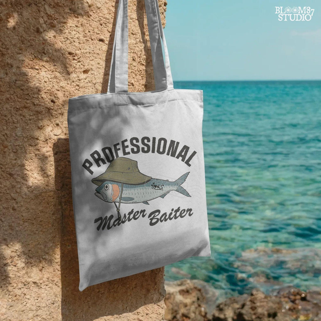 Funny fishing sublimation PNG with a fish wearing a green bucket hat and the words “Professional Master Baiter” in vintage bold font.