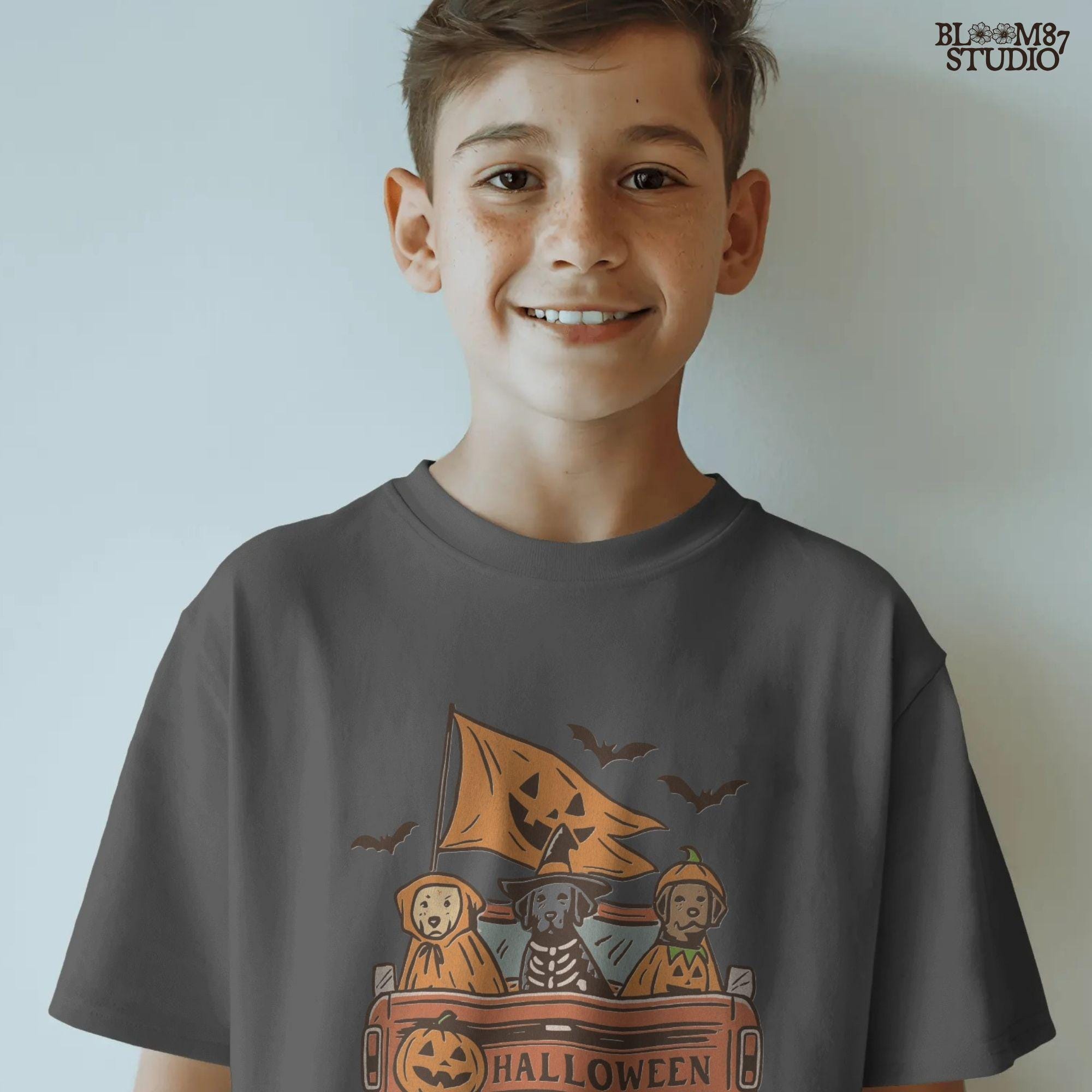 Halloween PNG of three dogs in Halloween costumes riding in a vintage truck with pumpkin flags and bats flying in the background.