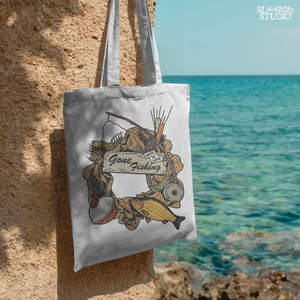 Rustic “Gone Fishing” wreath PNG design featuring bobber, fishing gear, reeds, yellow fish, and a wooden sign, perfect for sublimation on shirts and decor.