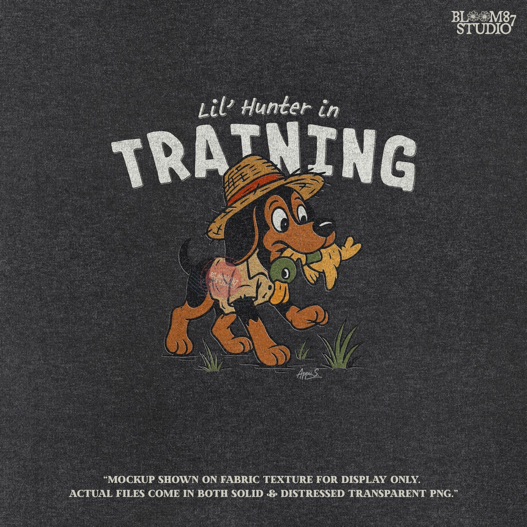 Cartoon hunting dog wearing straw hat and camo shirt holding duck toy in mouth with “Lil’ Hunter in Training” text – cute PNG for kids sublimation.