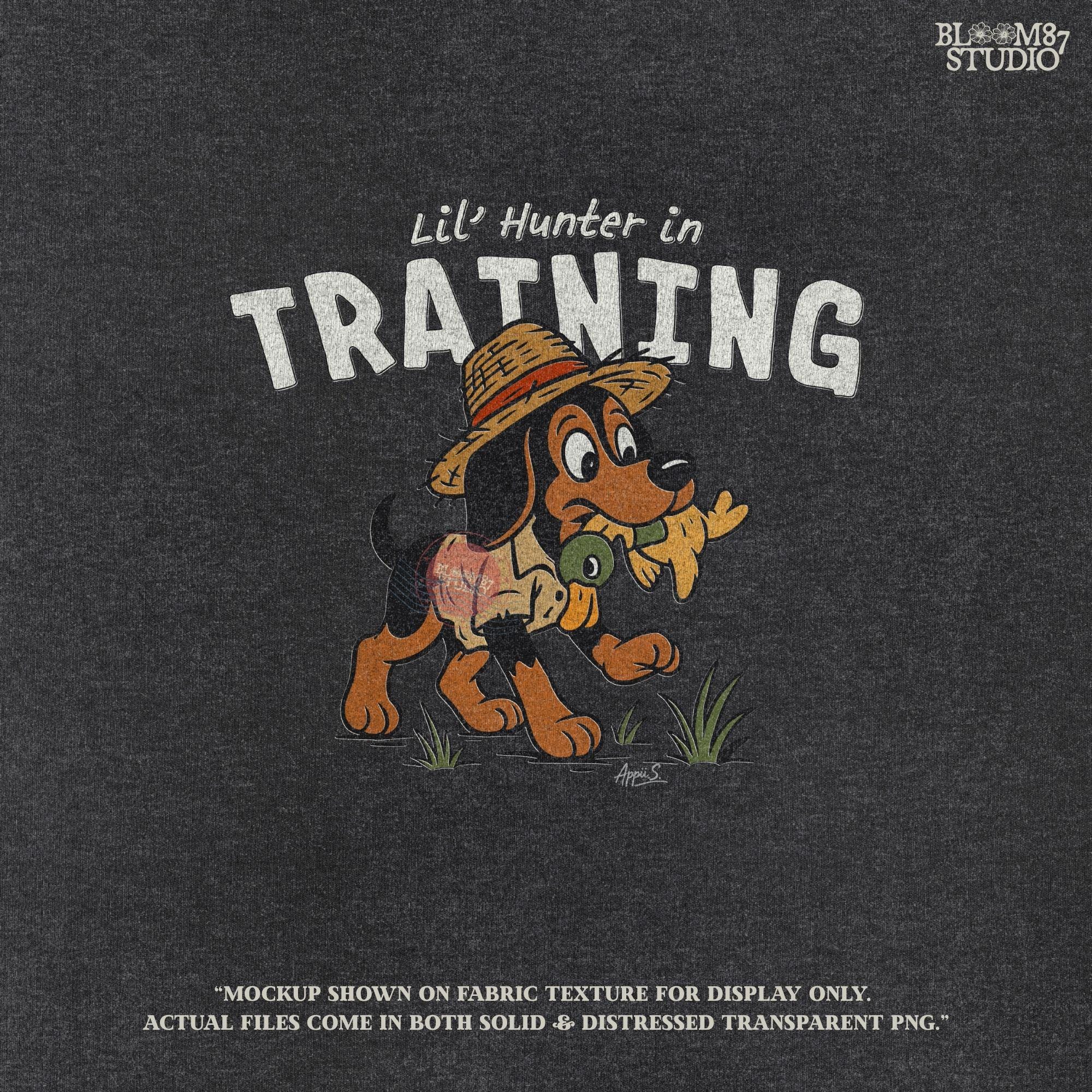 Cartoon hunting dog wearing straw hat and camo shirt holding duck toy in mouth with “Lil’ Hunter in Training” text – cute PNG for kids sublimation.
