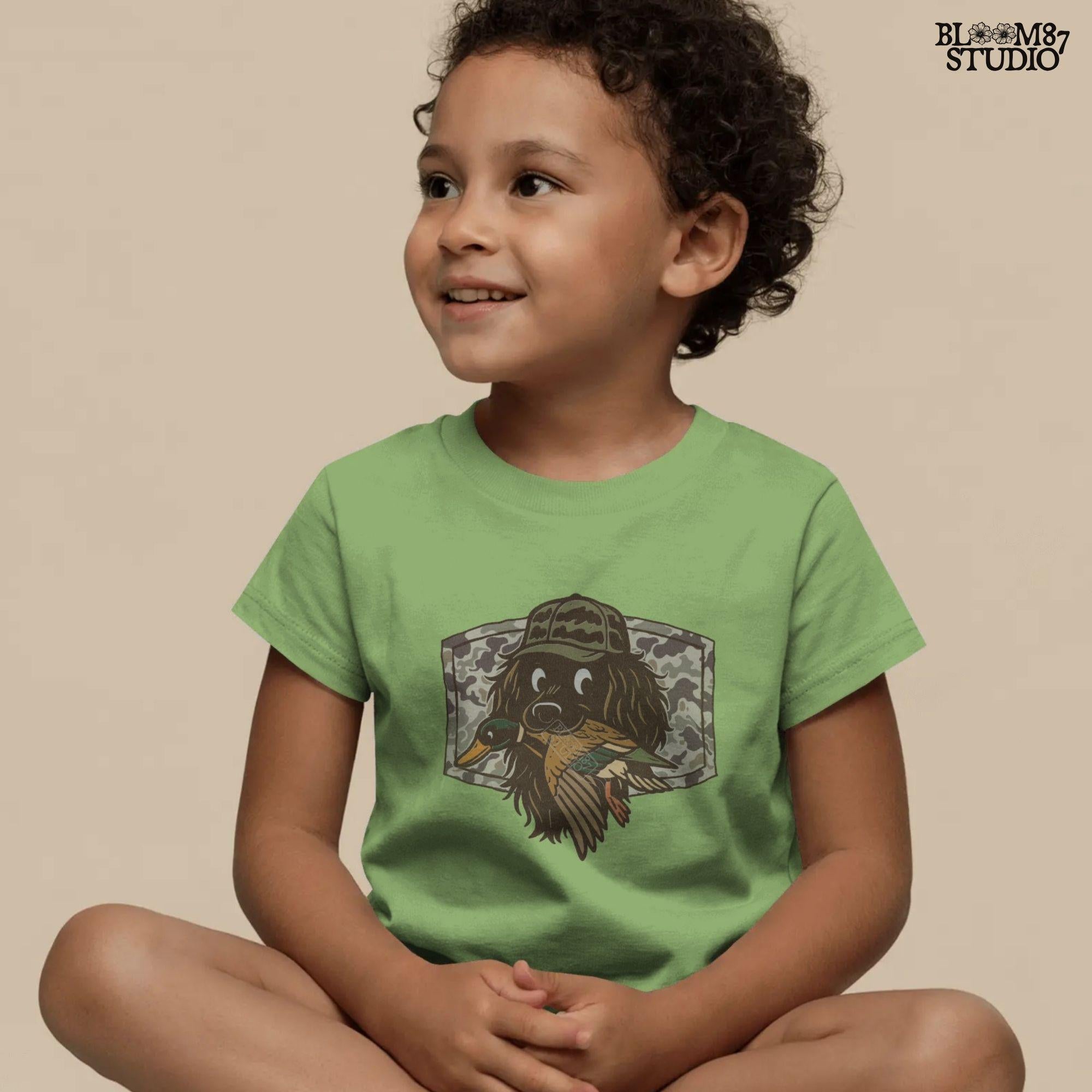 Cute cartoon hunting dog wearing camo hat holding a duck in its mouth with a camo background – sublimation PNG for boys or fall kids apparel design.