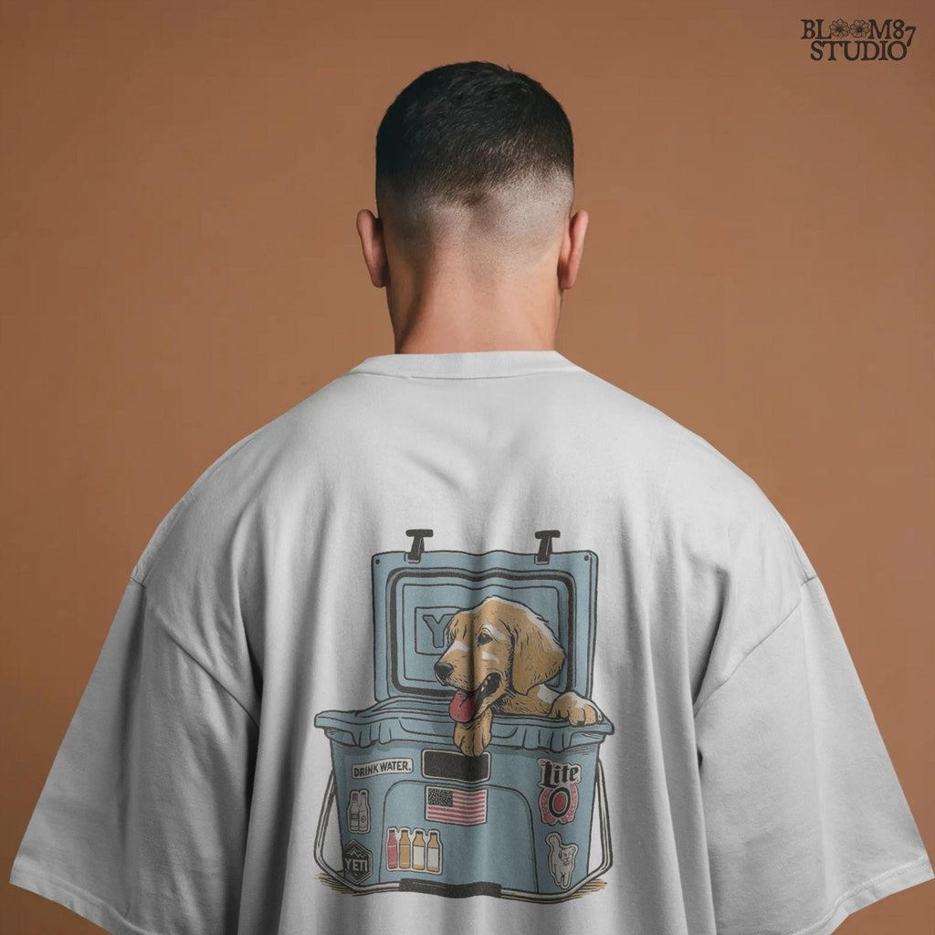 Illustration of a golden retriever puppy sitting inside a YETI cooler covered in stickers, designed for sublimation and lake life dog dad gifts.