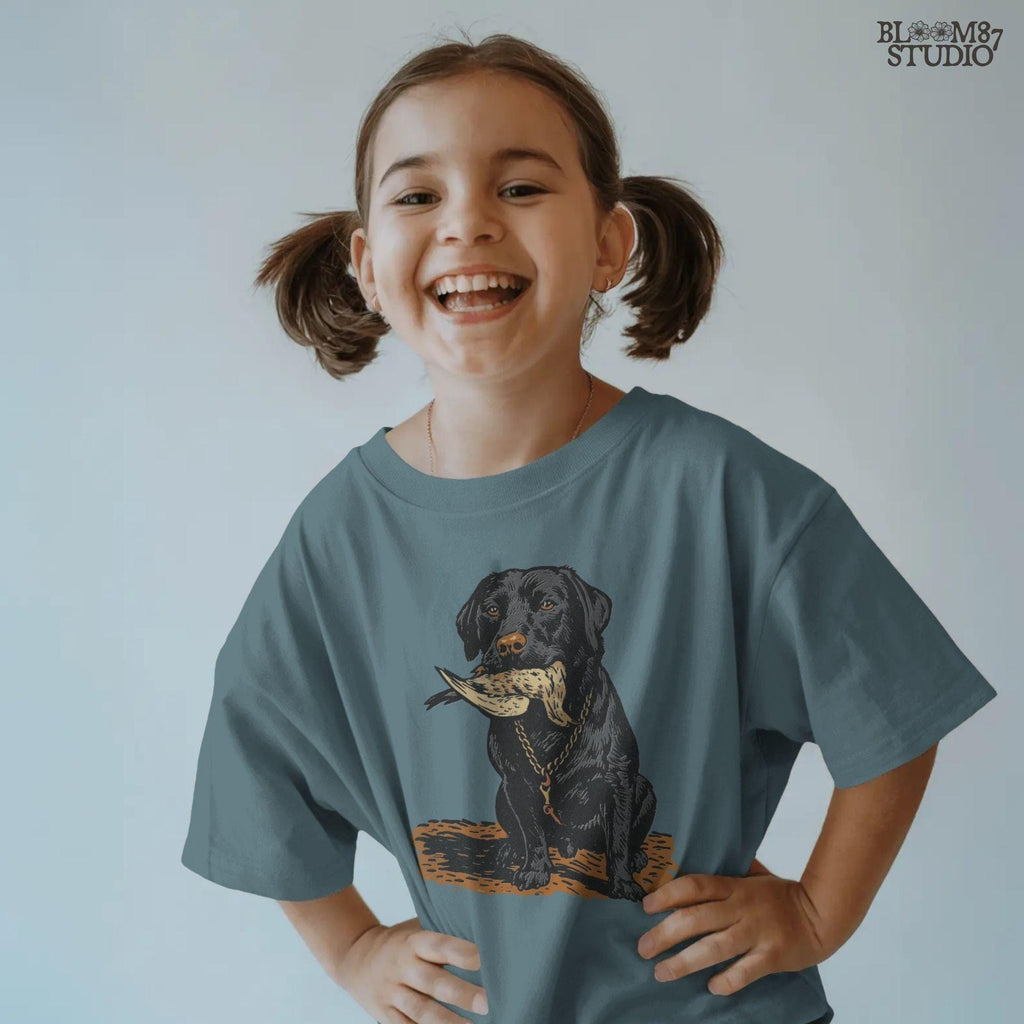 Black Labrador retriever sitting with a dove in its mouth, illustrated for dove hunting sublimation projects and bird dog gift designs.