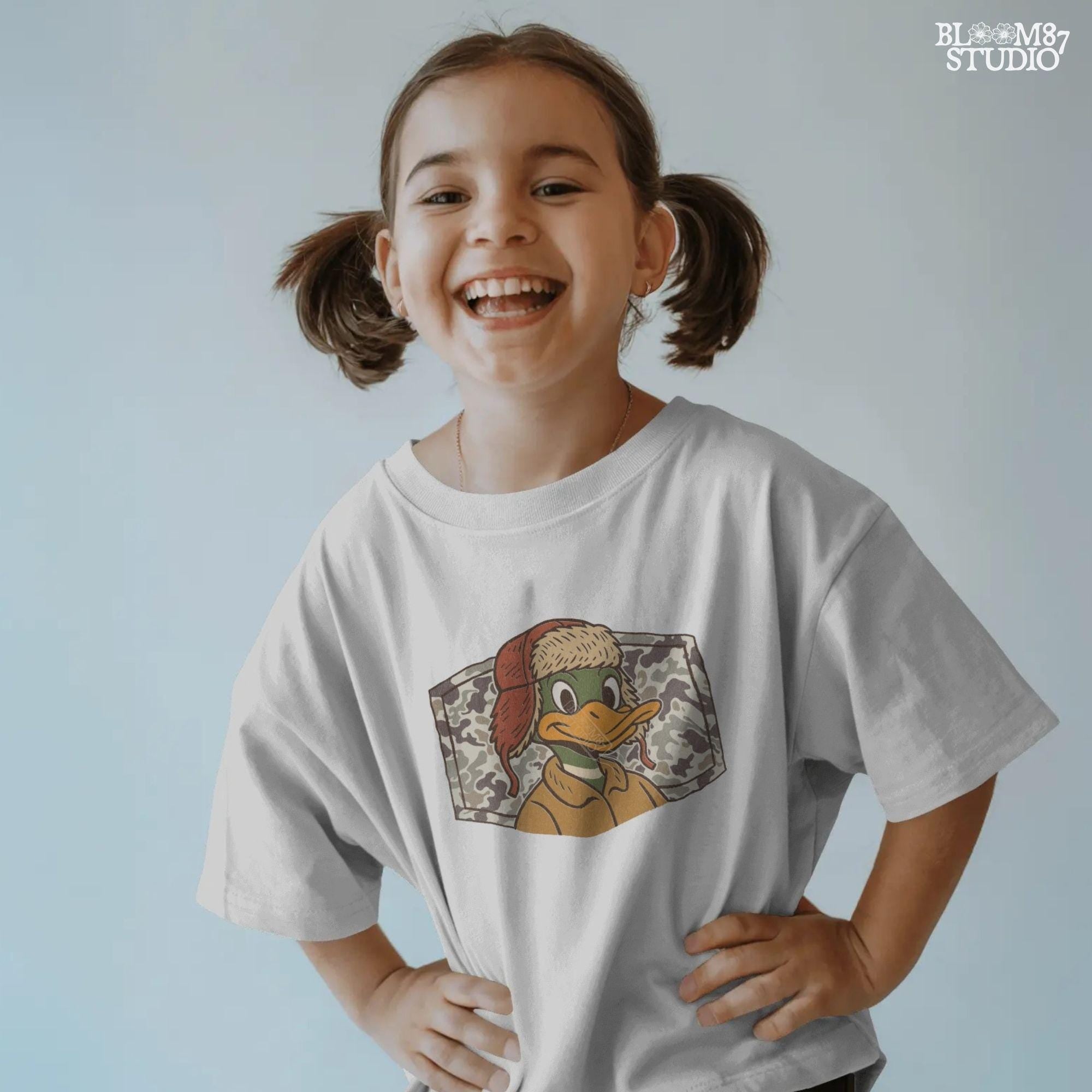 Cartoon duck in a trapper hat and camo jacket, kid-friendly hunting design with autumn theme, suitable for back to school sublimation.