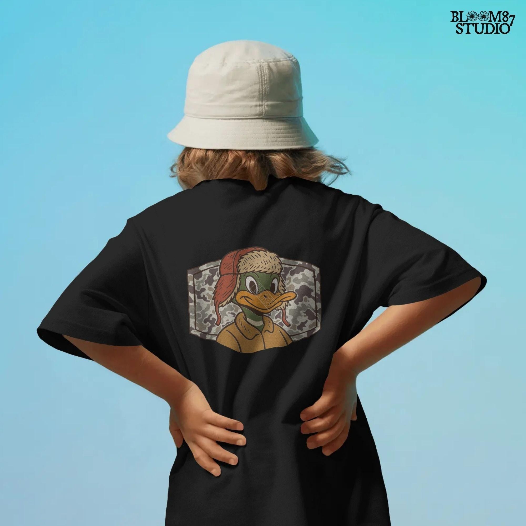 Cartoon duck in a trapper hat and camo jacket, kid-friendly hunting design with autumn theme, suitable for back to school sublimation.