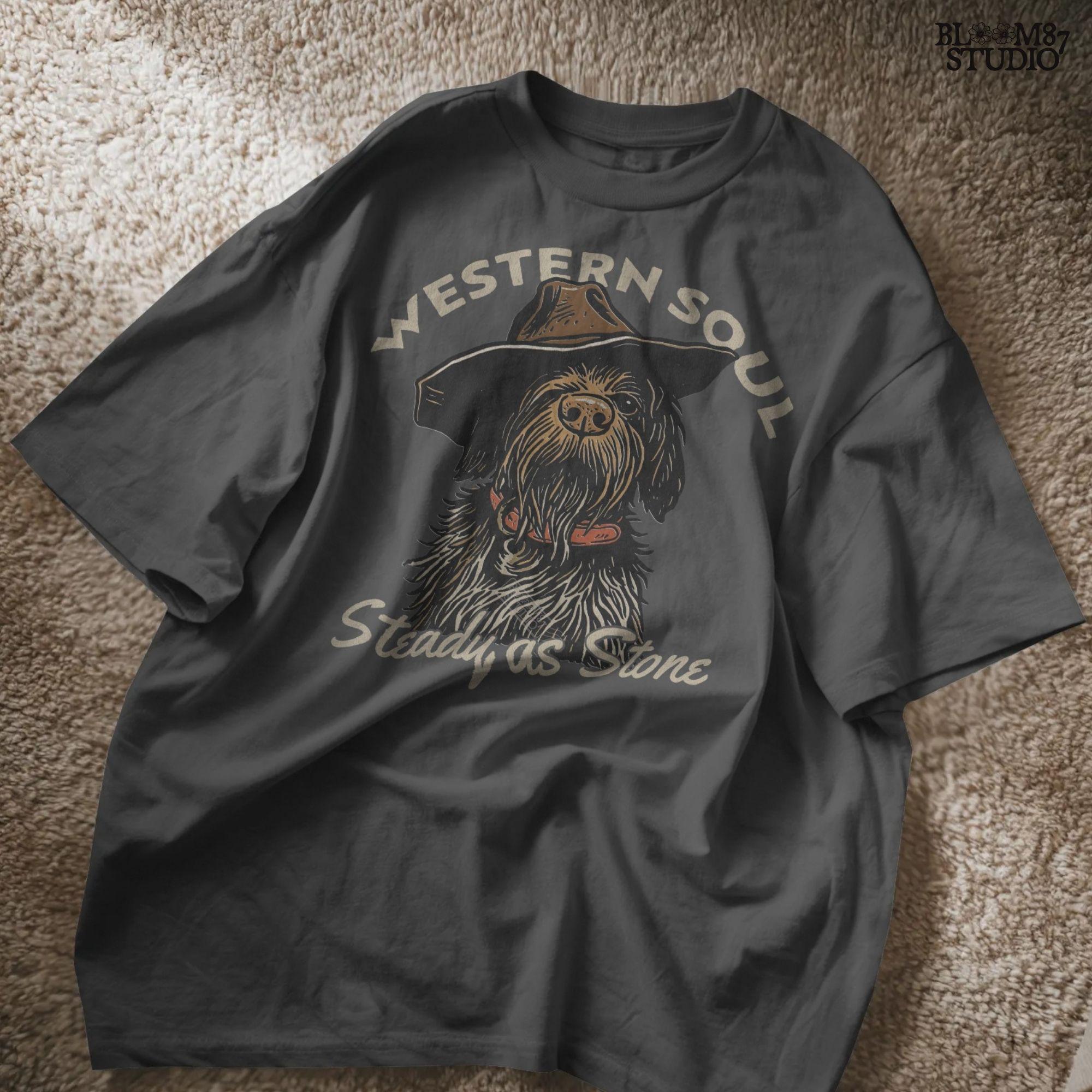 Rustic hunting dog with long fur and cowboy hat, labeled “Western Soul – Steady as Stone,” styled for western-themed sublimation and apparel use