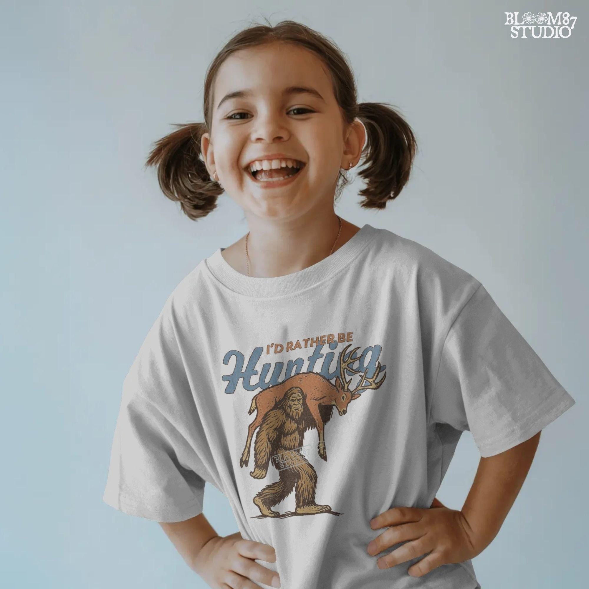 Illustration of Bigfoot carrying a deer on shoulders with text “I’d Rather Be Hunting,” designed for funny rustic sublimation projects