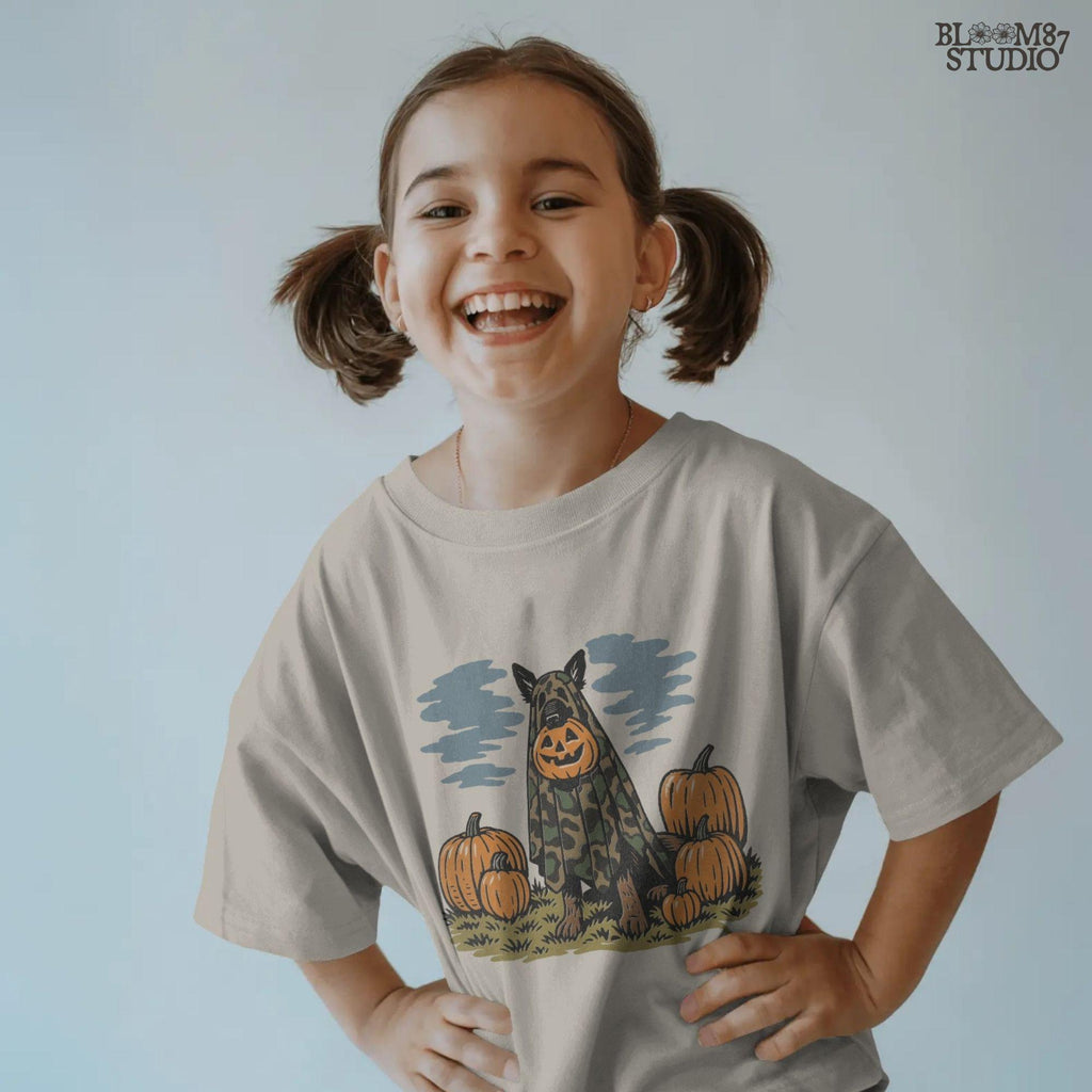 German Shepherd in camouflage ghost costume with jack-o’-lantern head surrounded by pumpkins, Halloween-themed sublimation design