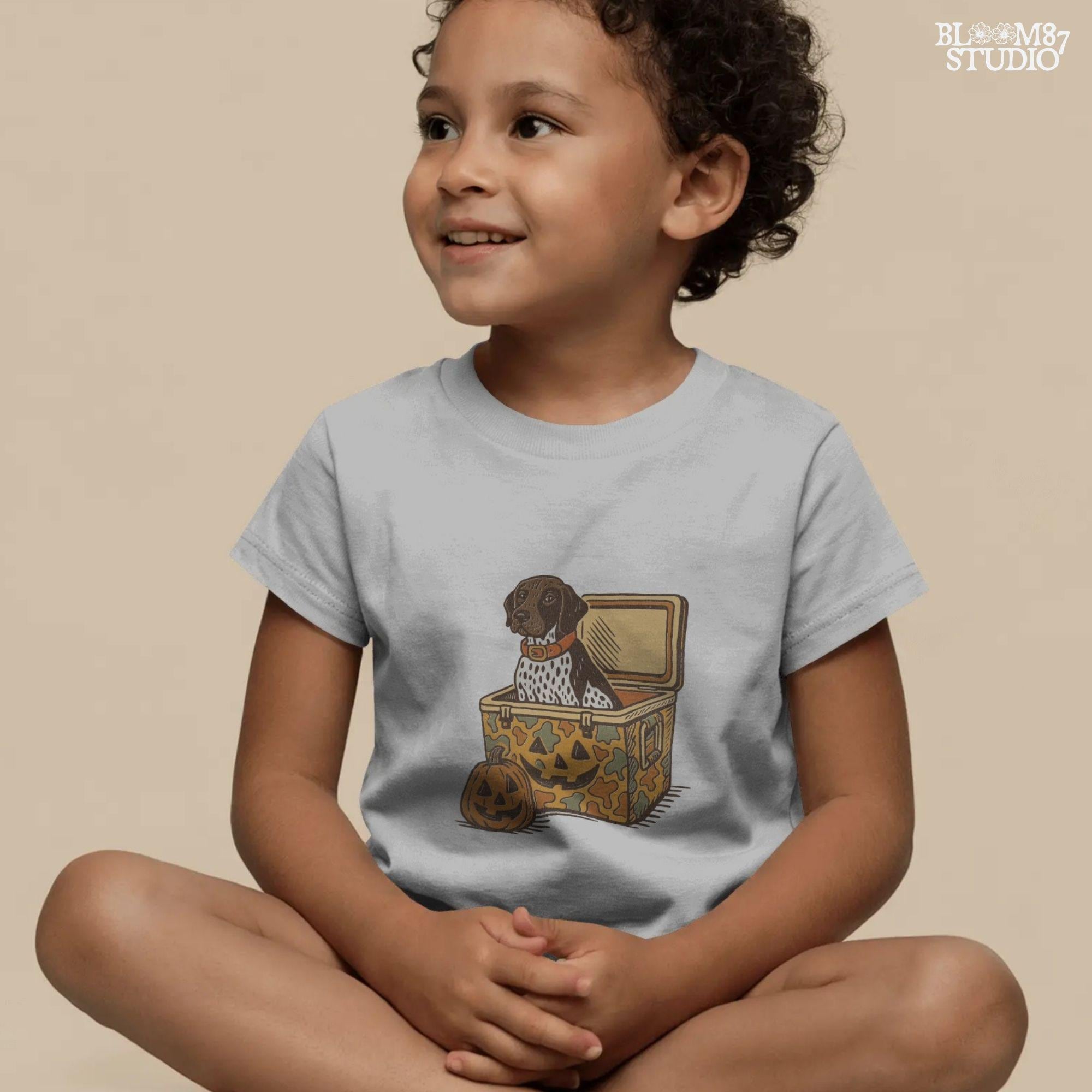 German Shorthair Pointer dog sitting inside a camo cooler with Jack O’ Lantern carvings, Halloween-themed sublimation PNG for fall shirts.