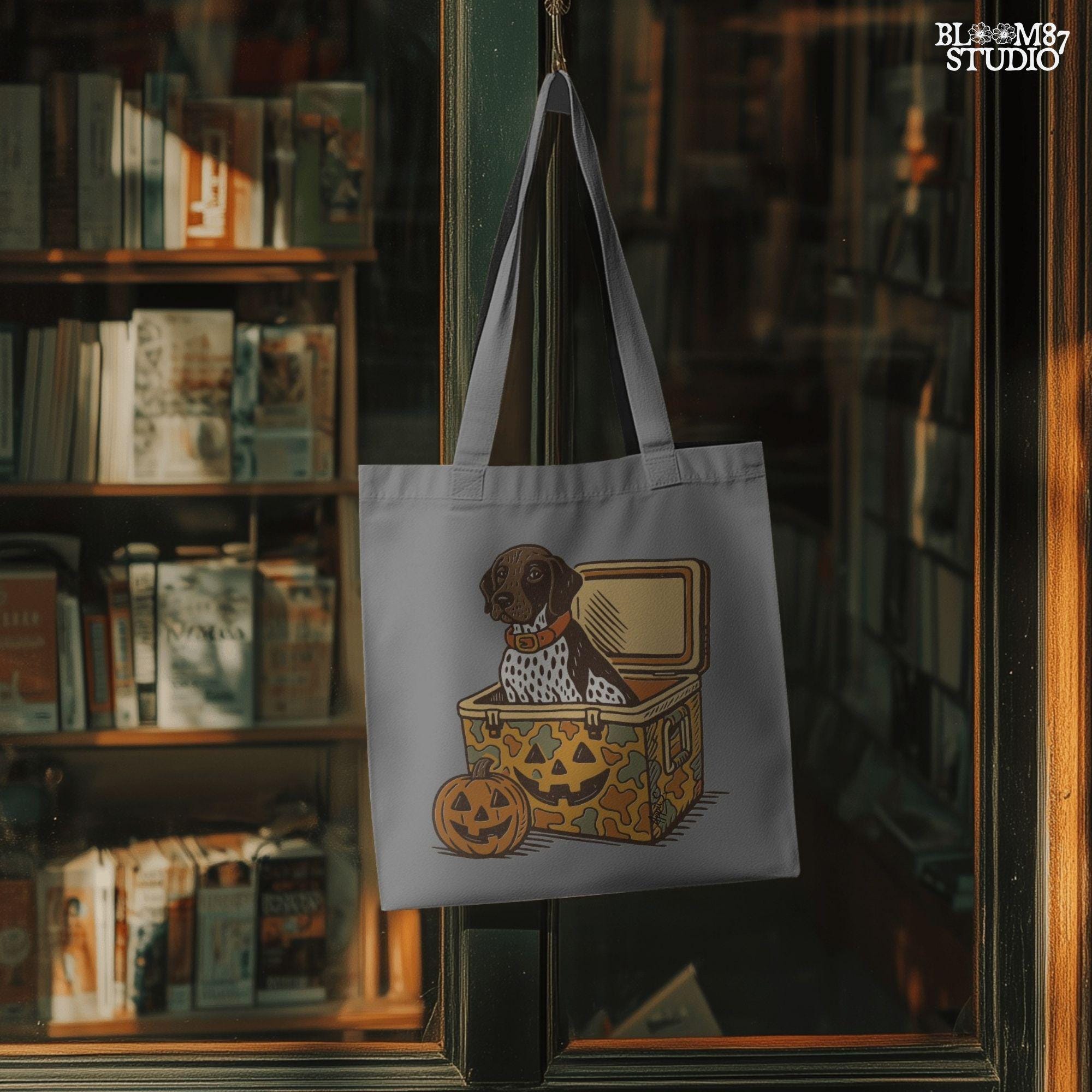 German Shorthair Pointer dog sitting inside a camo cooler with Jack O’ Lantern carvings, Halloween-themed sublimation PNG for fall shirts.