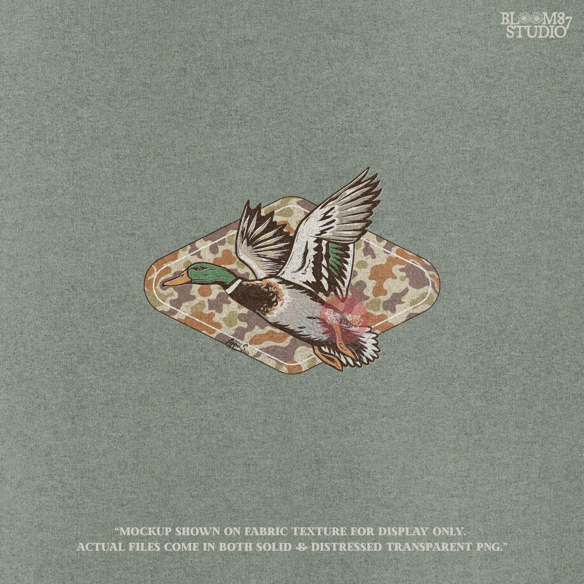 Mallard duck flying over a tan and brown woodland camo background, stylized for fall hunting and Thanksgiving sublimation projects.