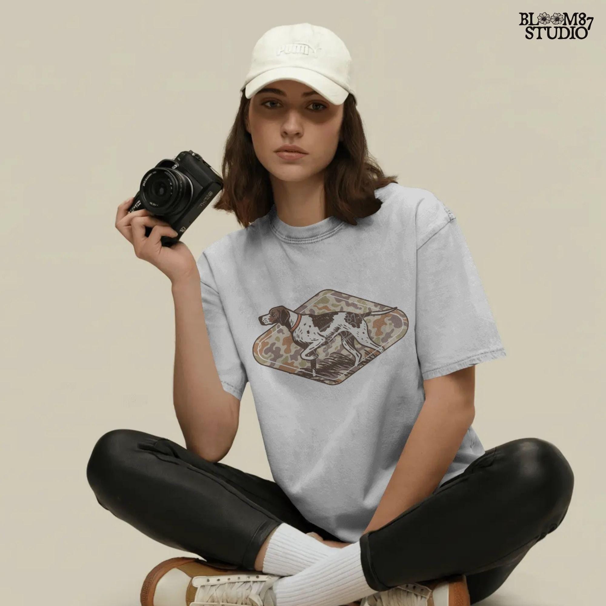 Brown and white hunting pointer dog in a standing pose over a woodland camo background, perfect for fall or Thanksgiving-themed sublimation designs.