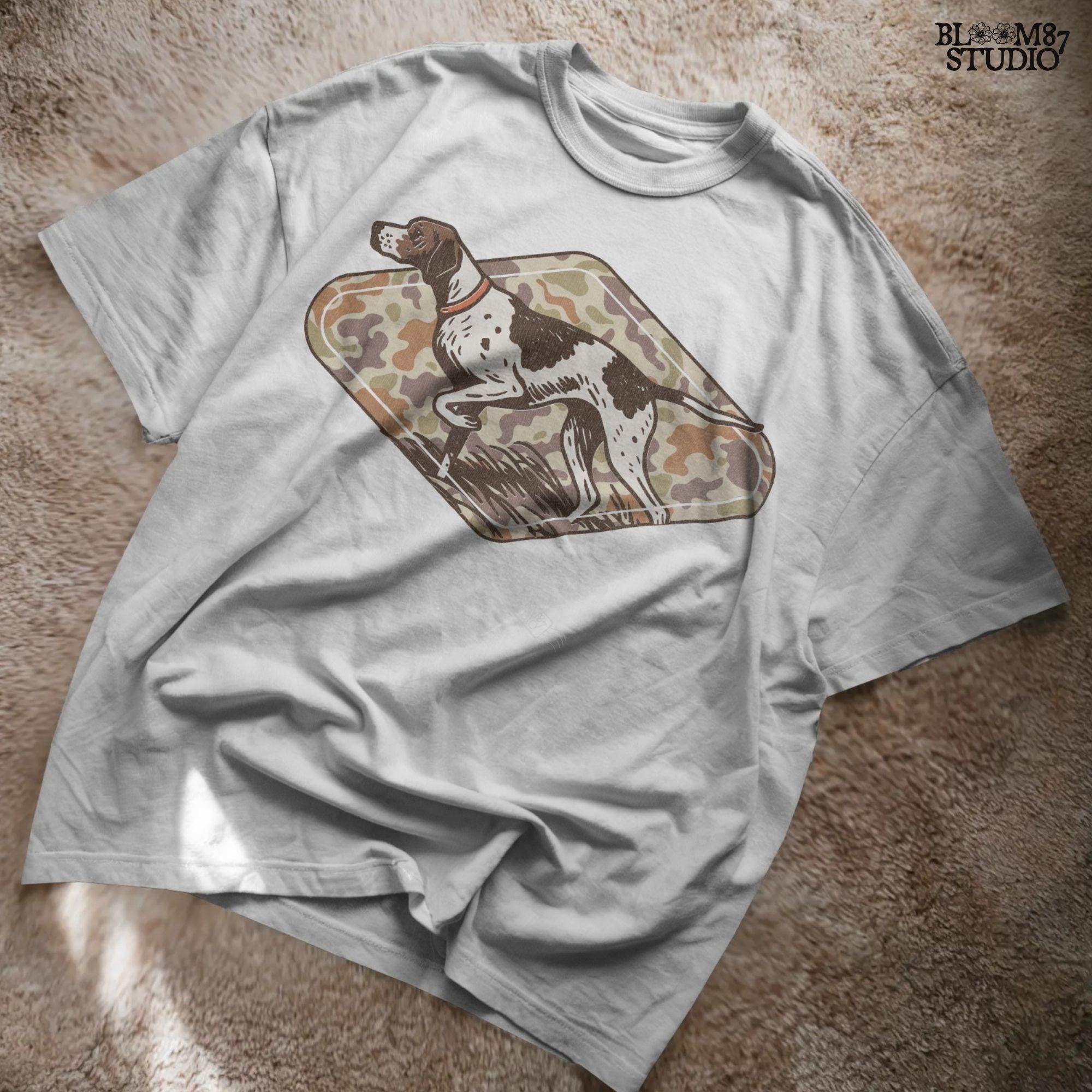 Brown and white hunting pointer dog in a standing pose over a woodland camo background, perfect for fall or Thanksgiving-themed sublimation designs.