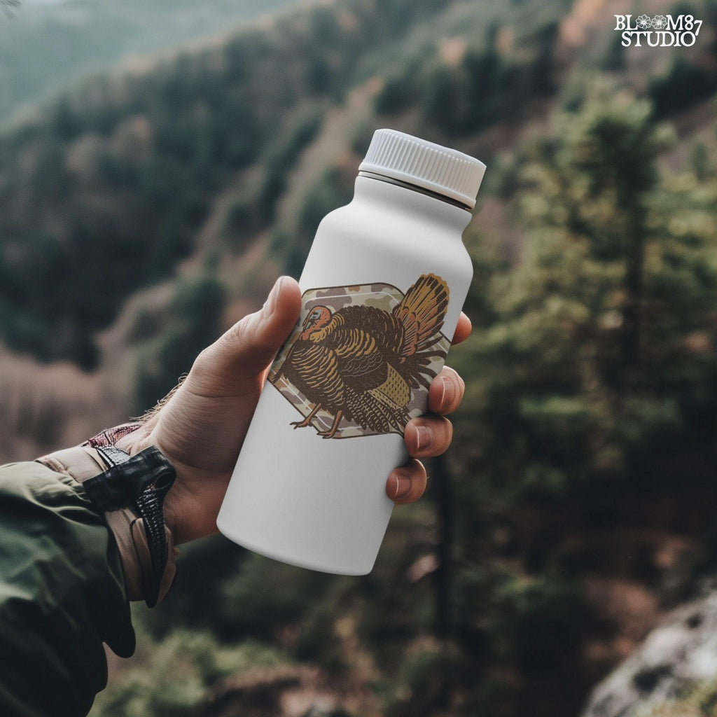 Illustration of a wild turkey with full plumage standing over a tan woodland camouflage background, ideal for fall or Thanksgiving sublimation designs.