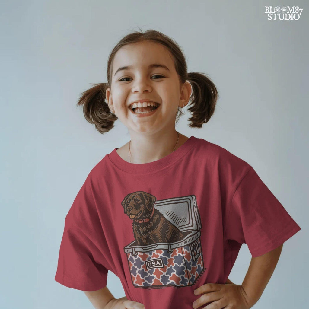 Patriotic sublimation PNG of a brown Labrador sitting inside a red, white, and blue USA-themed cooler, perfect for July 4th crafts and shirts